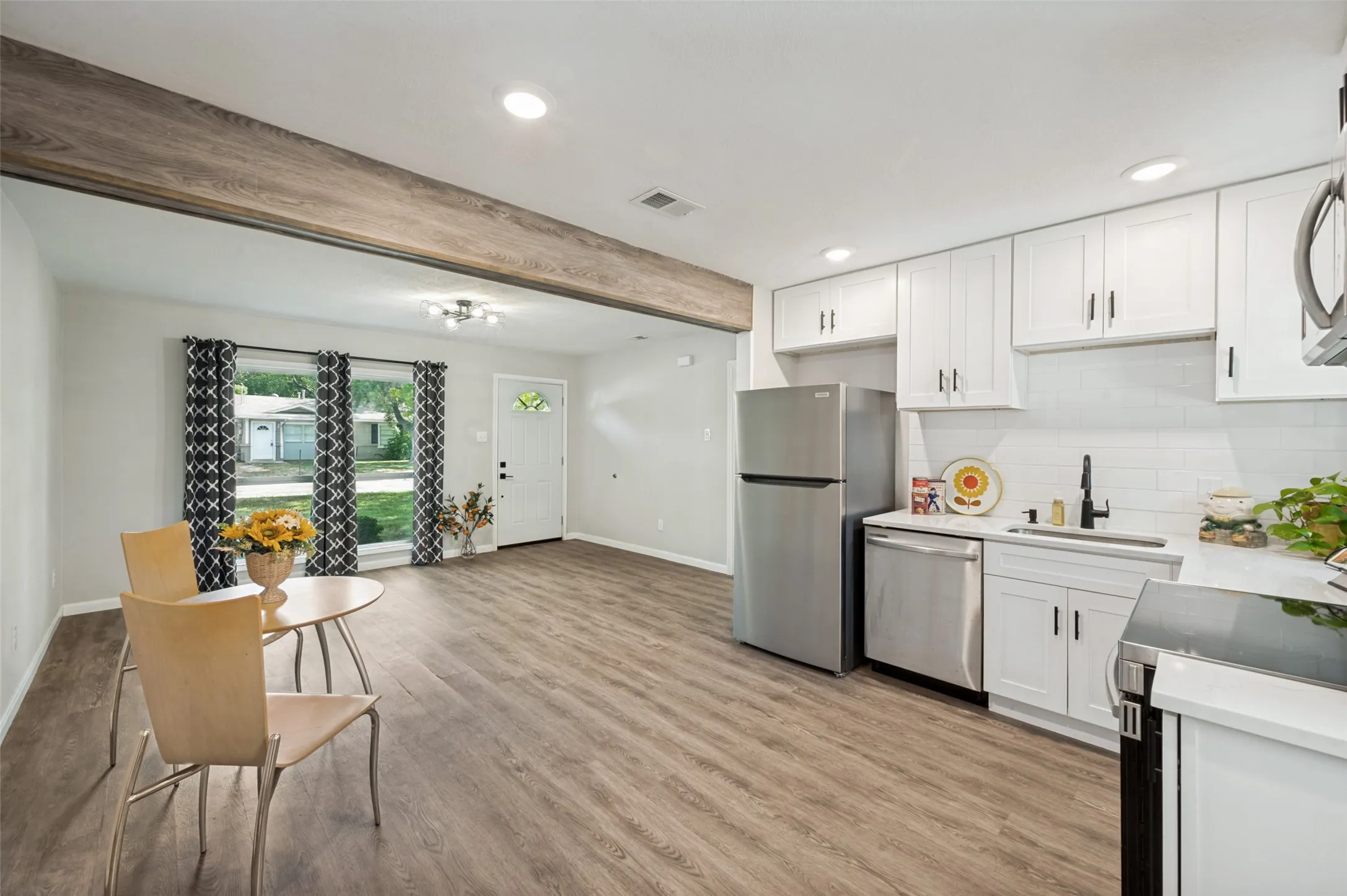 Living Room and Kitchen with big windows to the front yard.