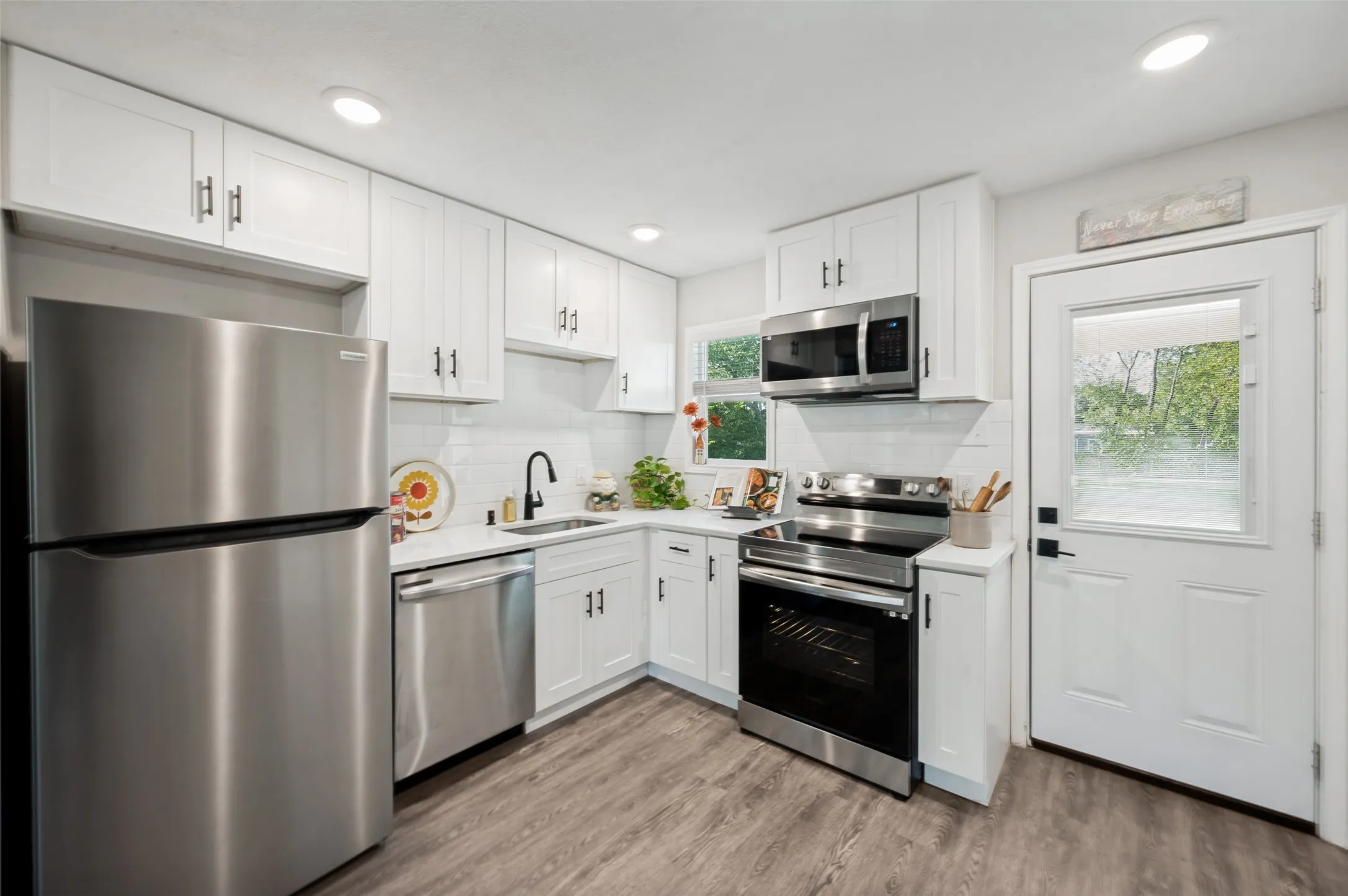 Modern Kitchen includes a single basin sink, dishwasher, refrigerator, micro and smooth top range.