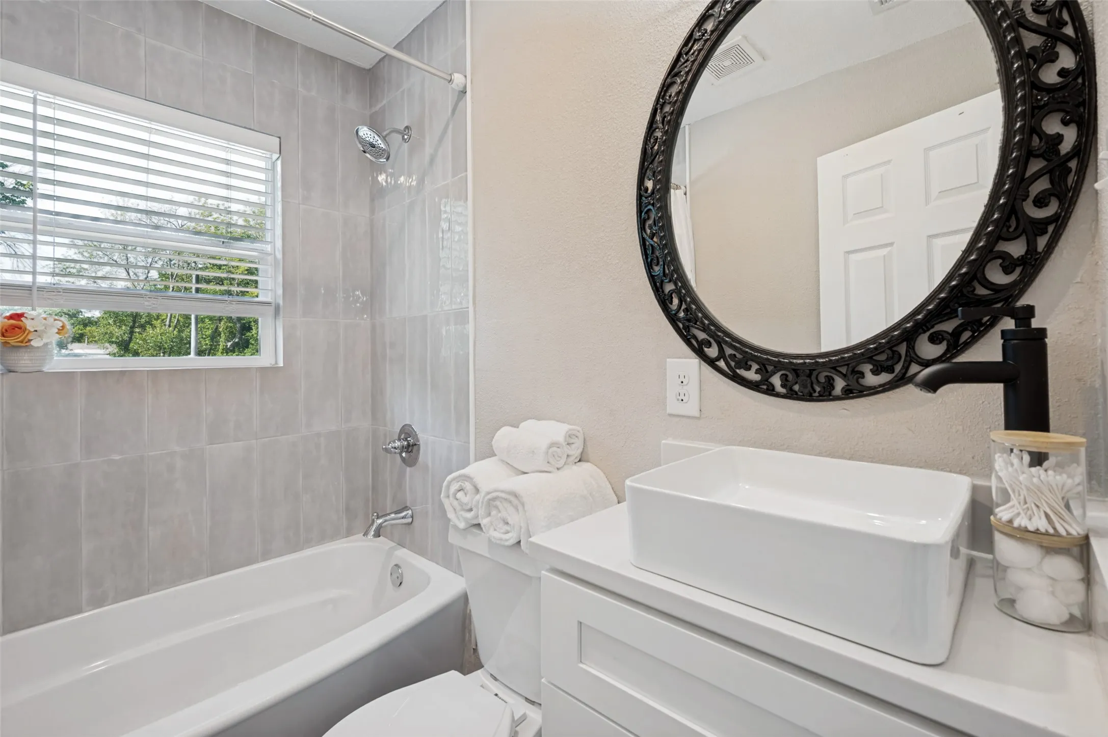 Spa like guest bathroom with beautiful tile and a nice tub.