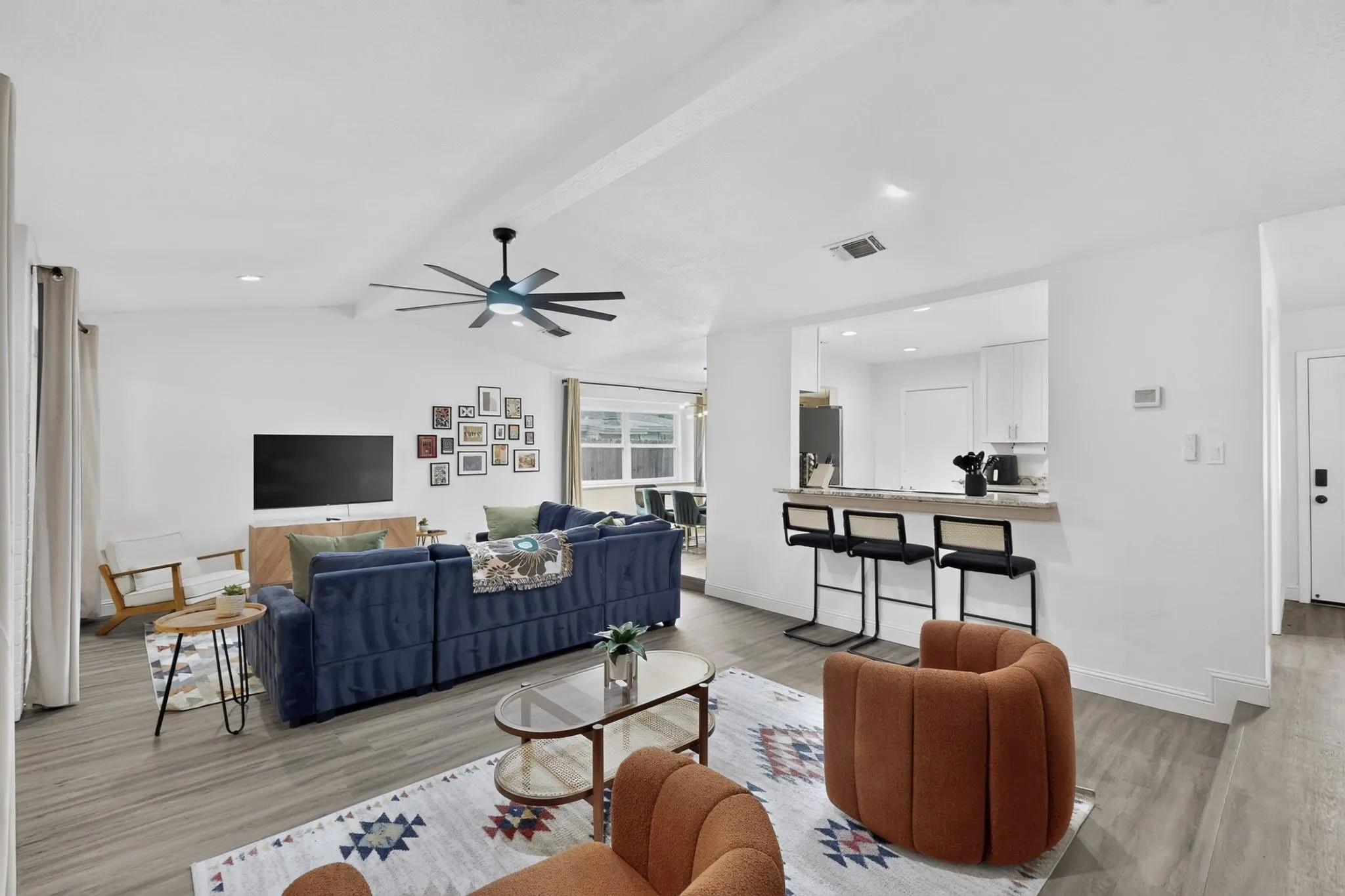 Open-concept living space featuring wood-finish flooring and recessed lighting