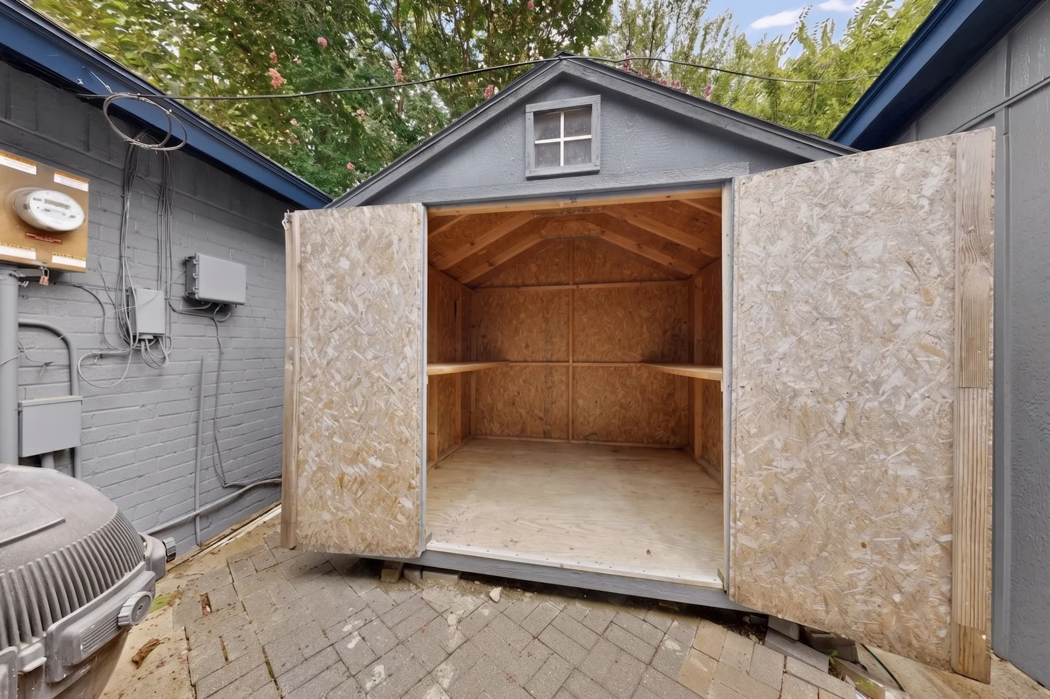 Detached storage shed with double doors and an interior shelf system