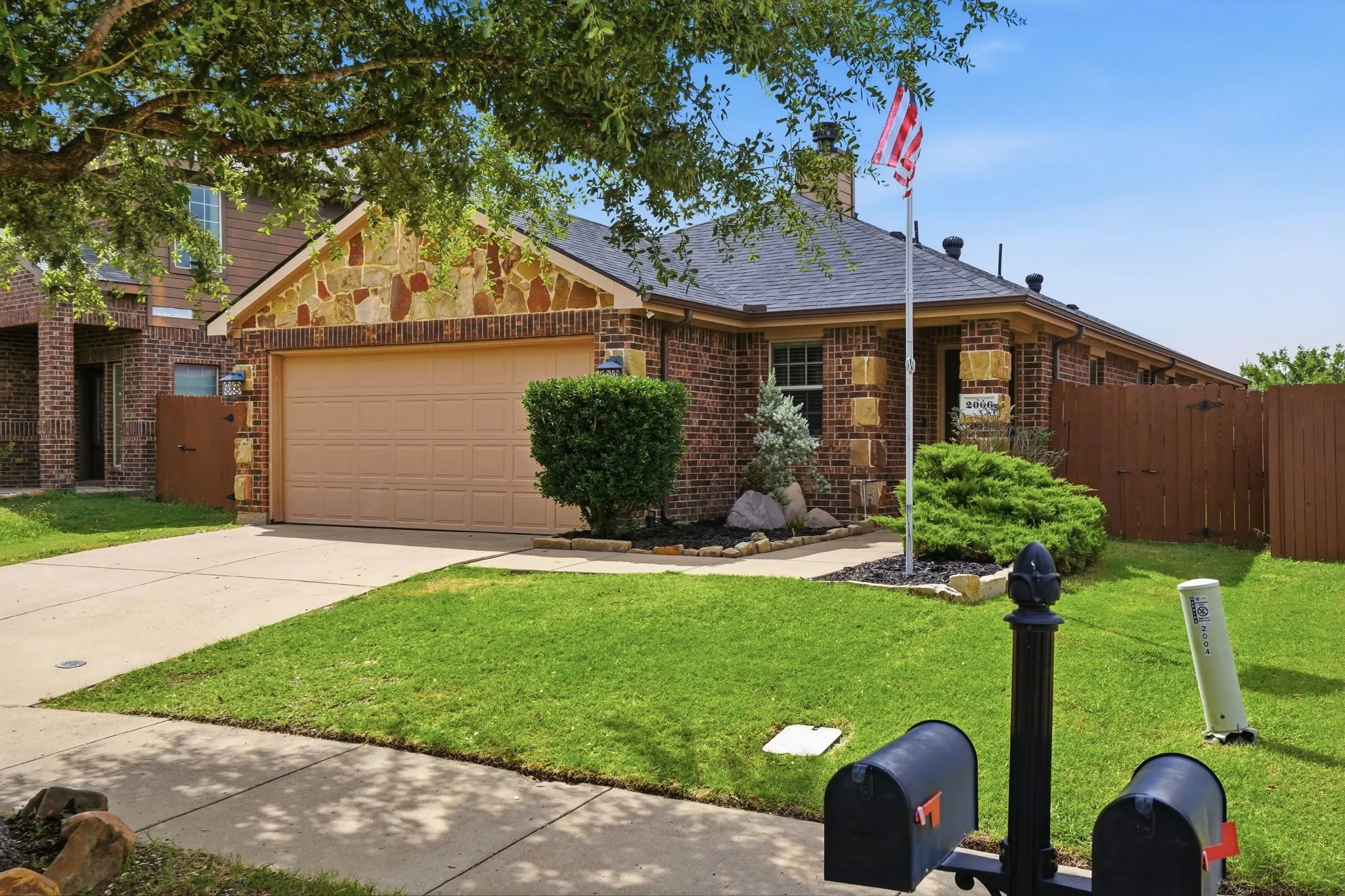 Brick exterior with stone accents and a two-car garage