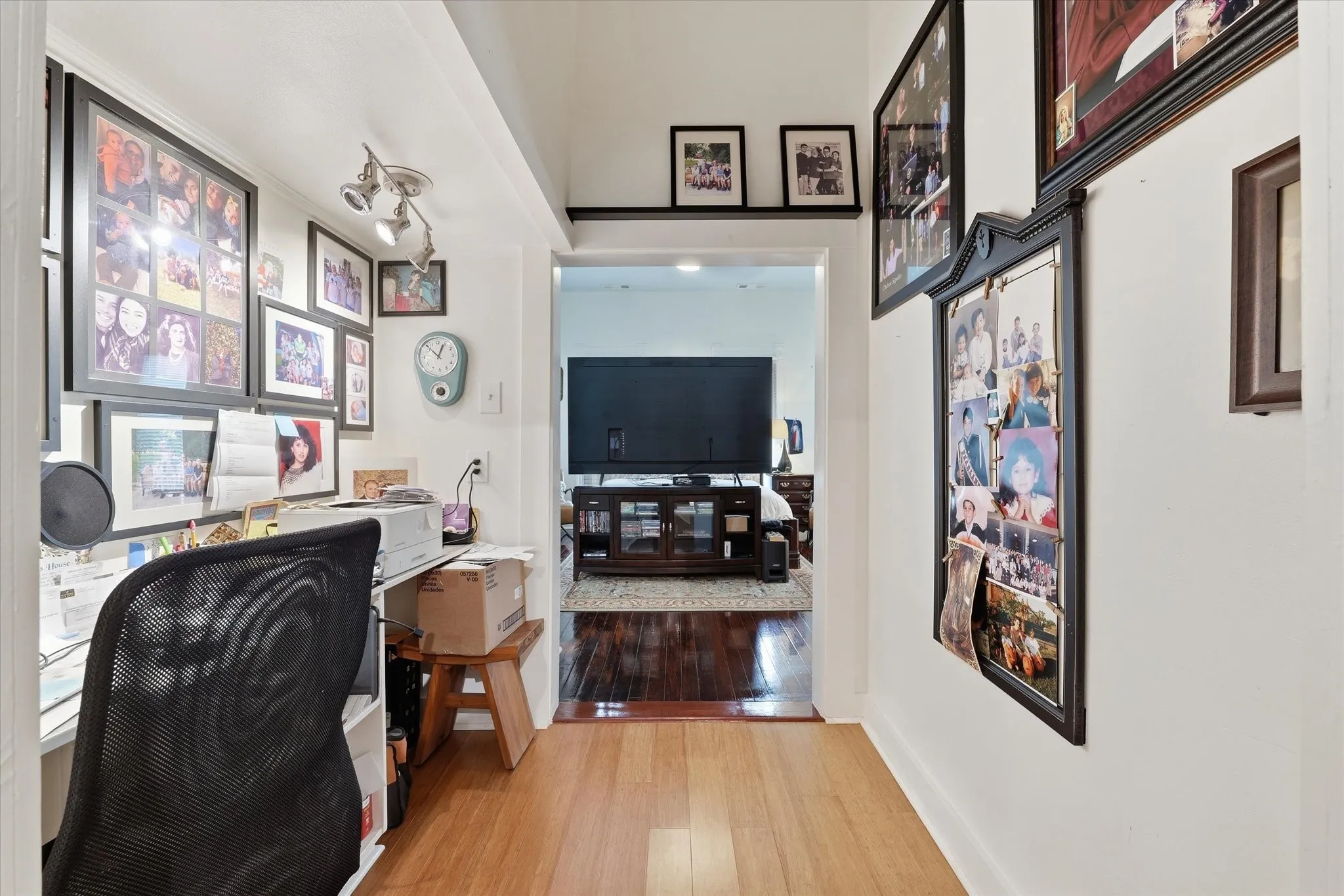 Small office with built-in desk off primary room