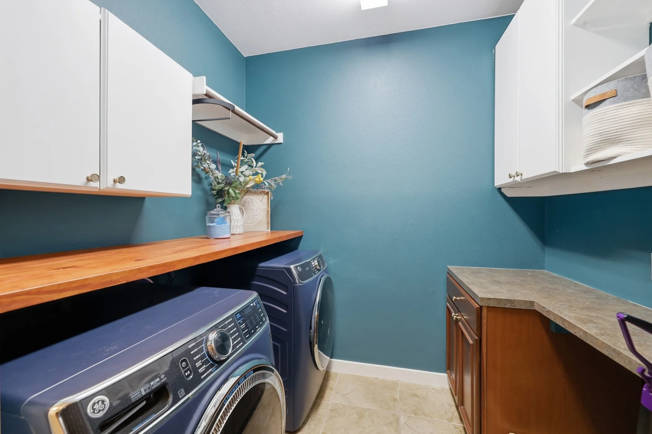 Lovely laundry room! with plenty of storage!