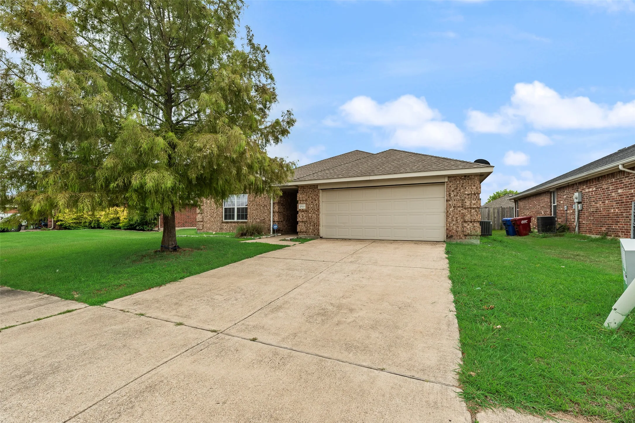 Brick exterior with a prominent front-facing garage door