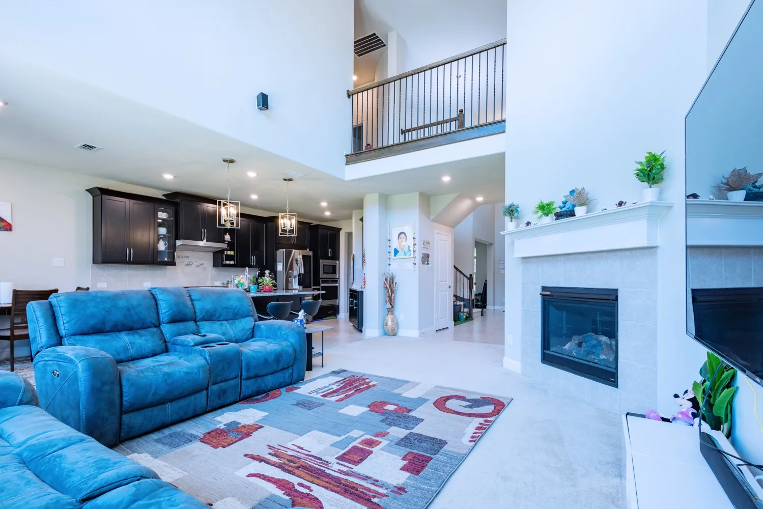 Open-concept living space with a two-story ceiling and an upper-level overlook