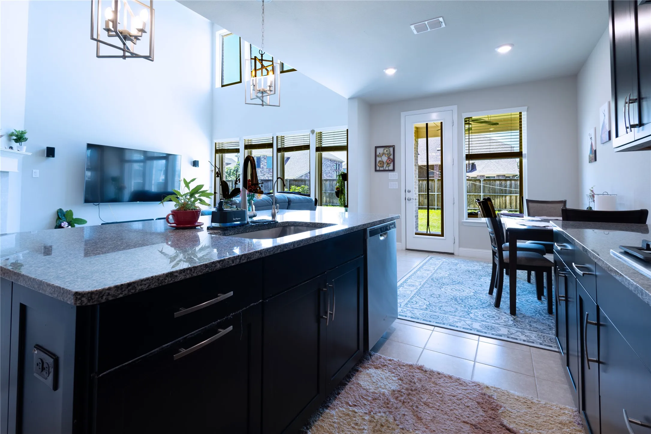 Kitchen island featuring a granite countertop and dark wood cabinetry