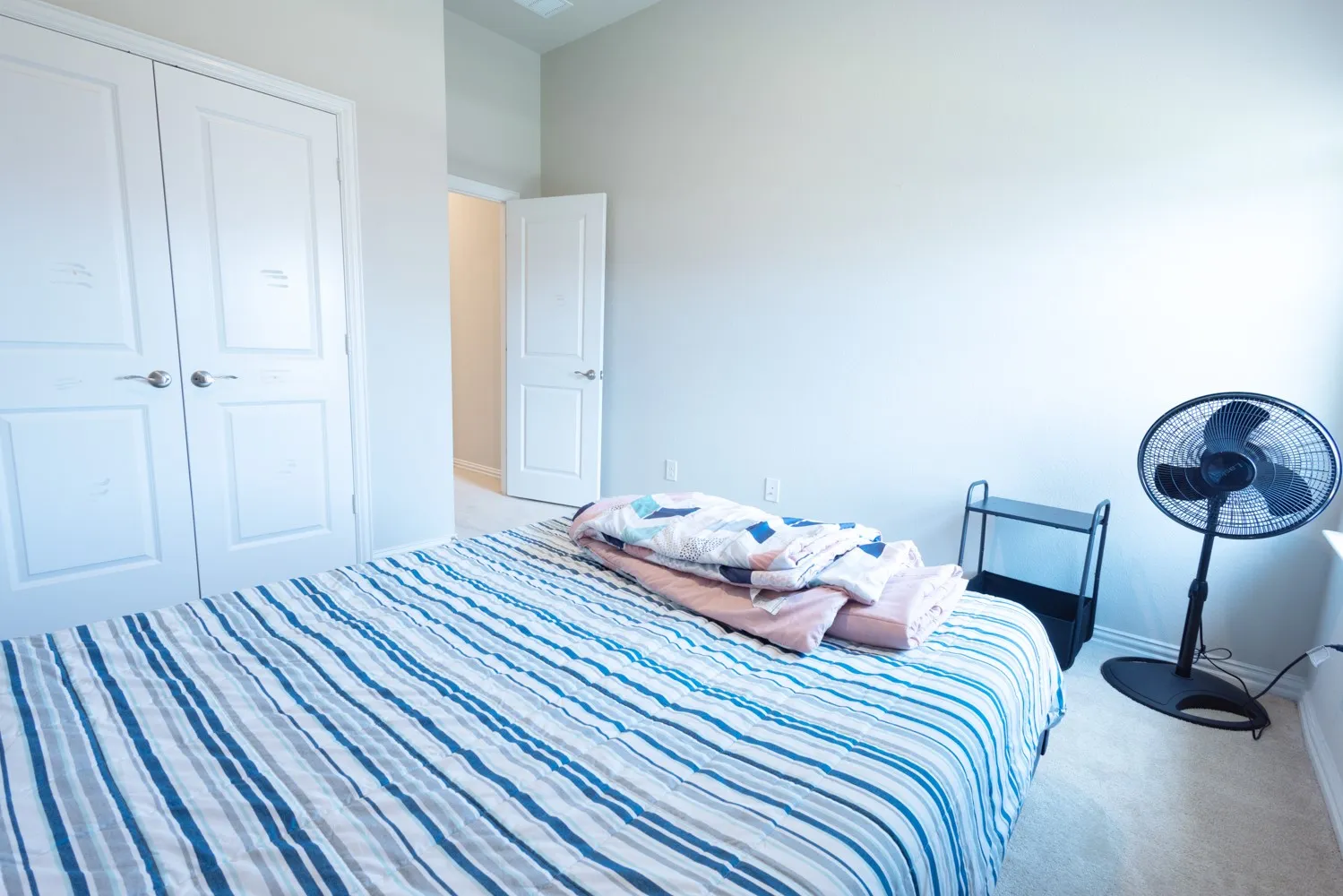 Room featuring light-colored walls and neutral-toned carpet