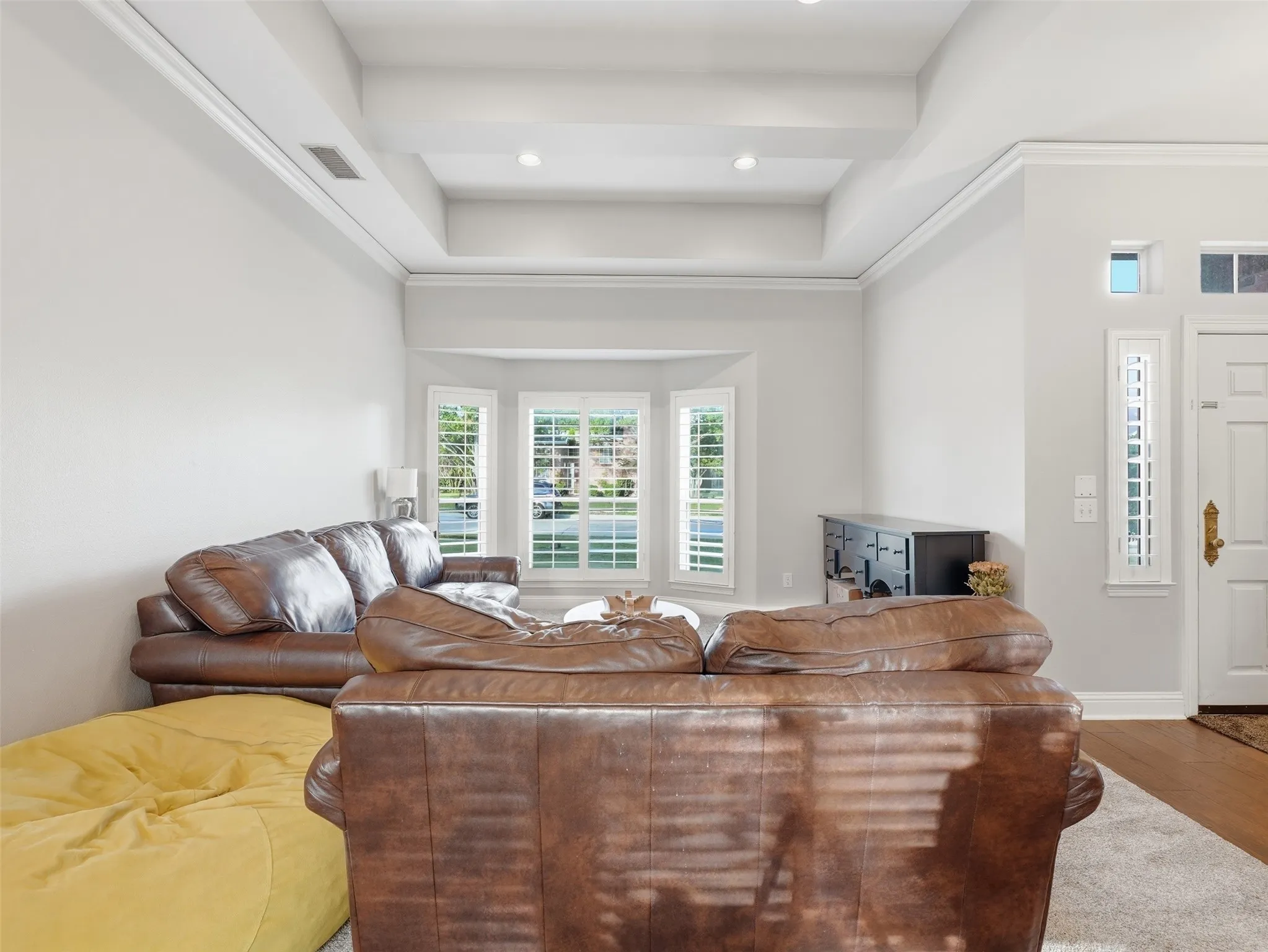 Formal Living area featuring a tray ceiling with recessed lighting, crown molding, and light gray wall color
