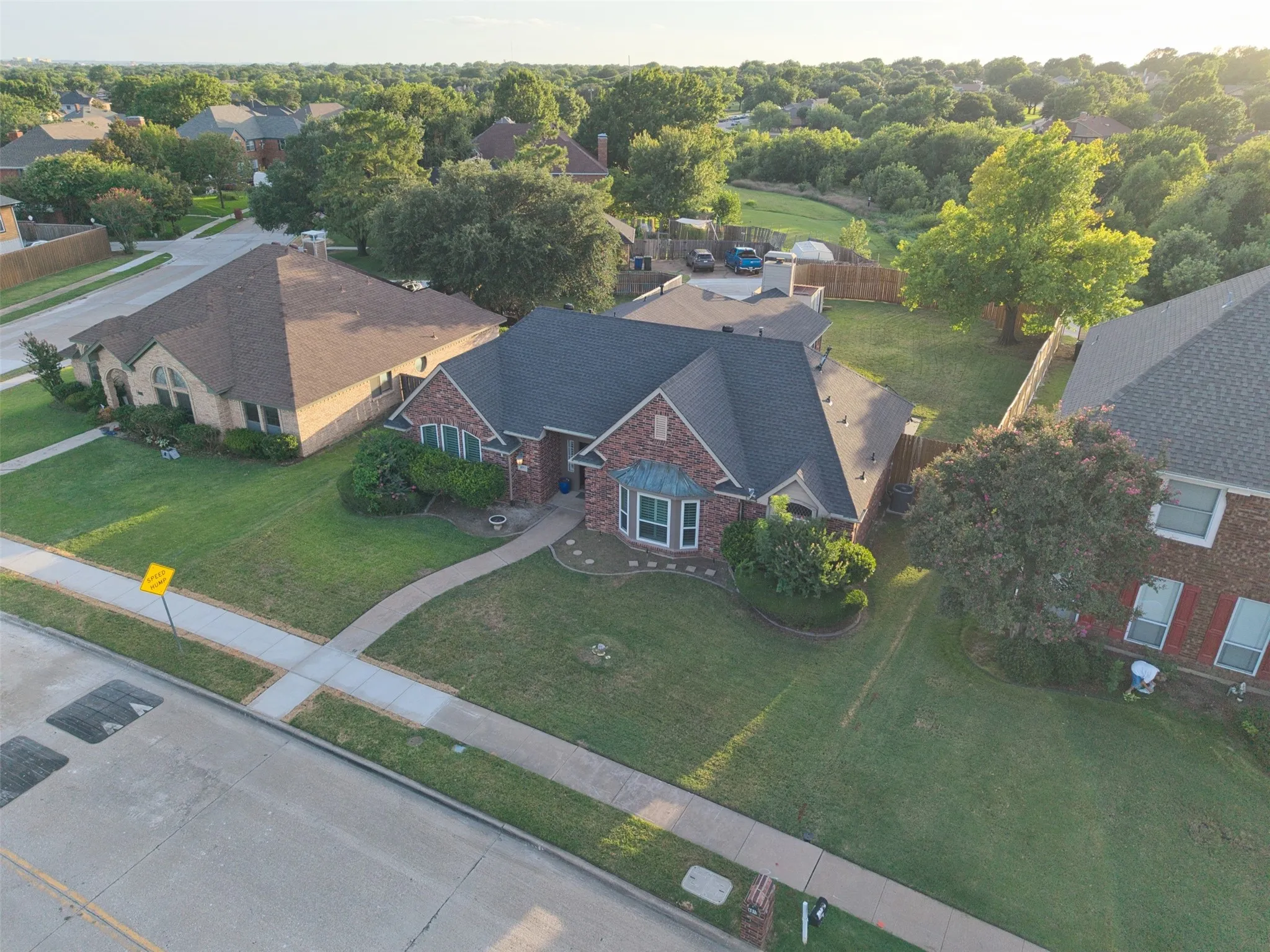 Brick exterior with stone accents and dark shingle roofing