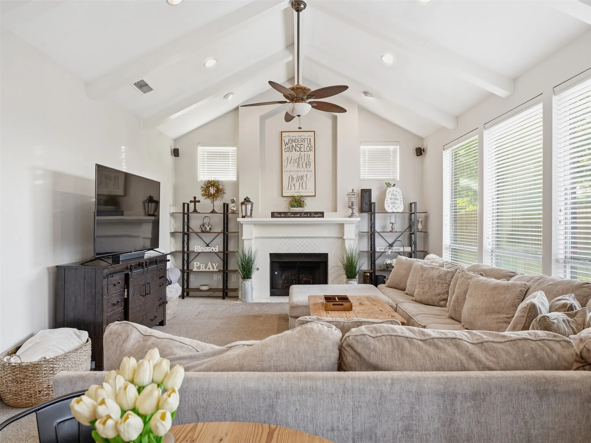 Vaulted ceiling with exposed beams and recessed lighting