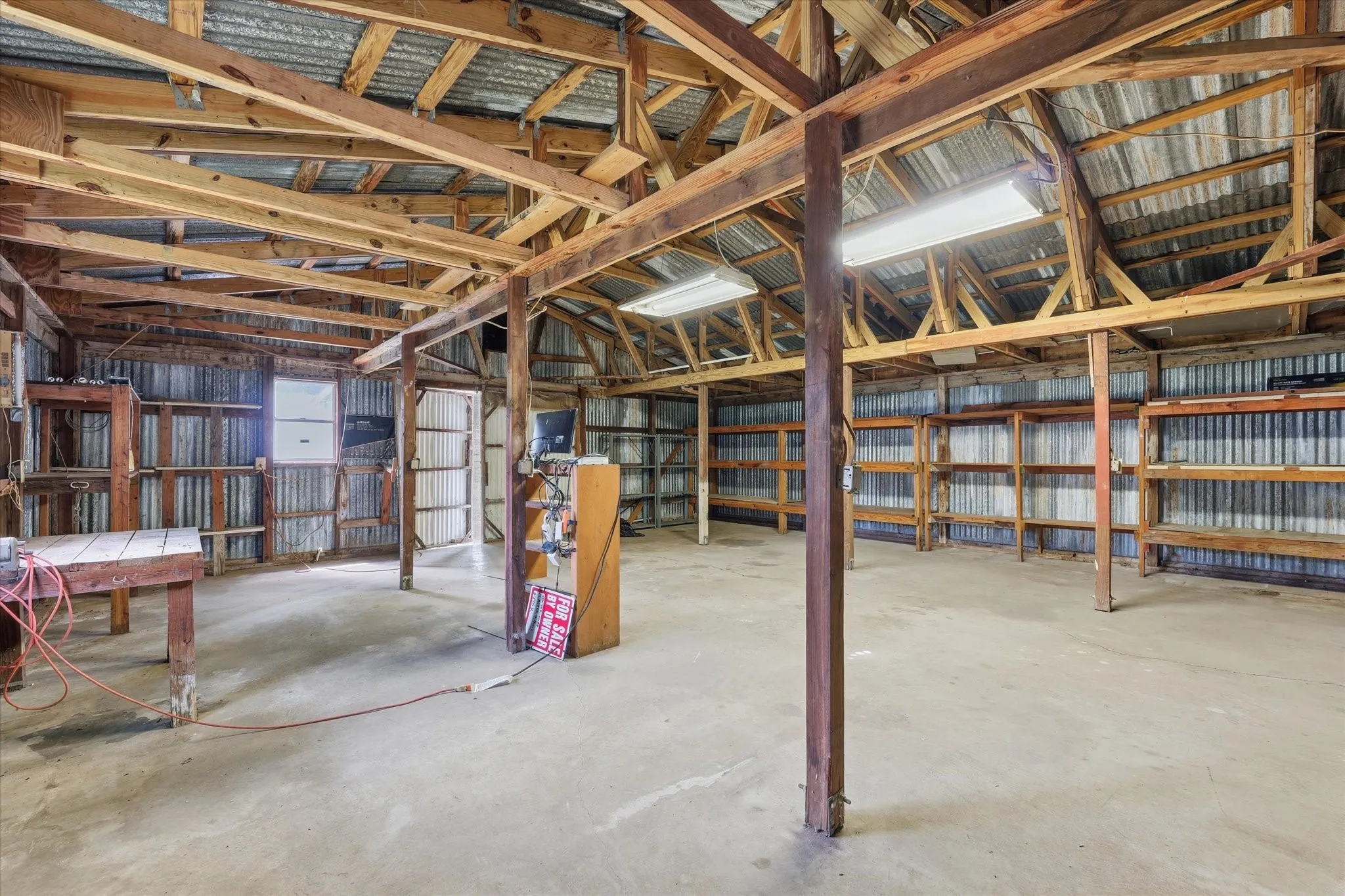 Spacious workshop sits on a slab with electricity in place.
