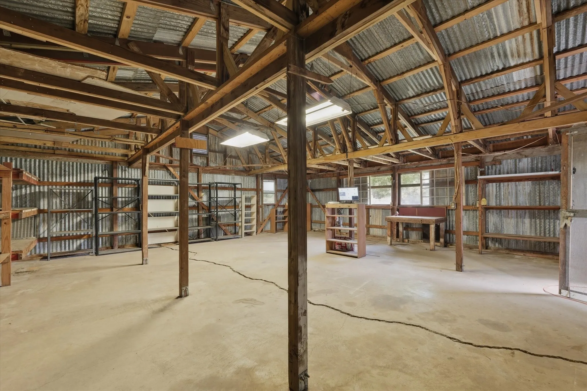 Spacious workshop sits on a slab with electricity in place.