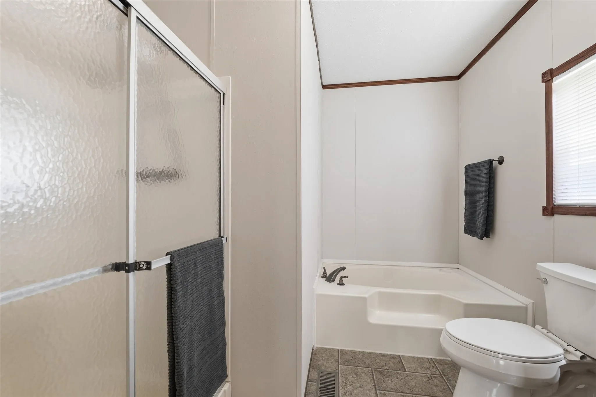 Walk-in shower and garden tub in primary bath.