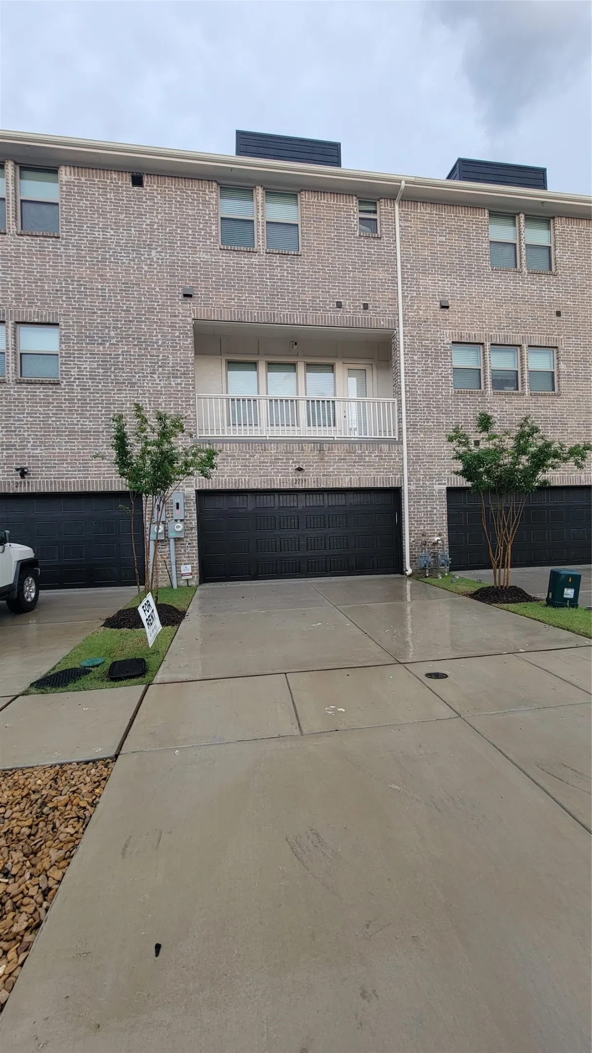 View of property featuring a garage and big balcony