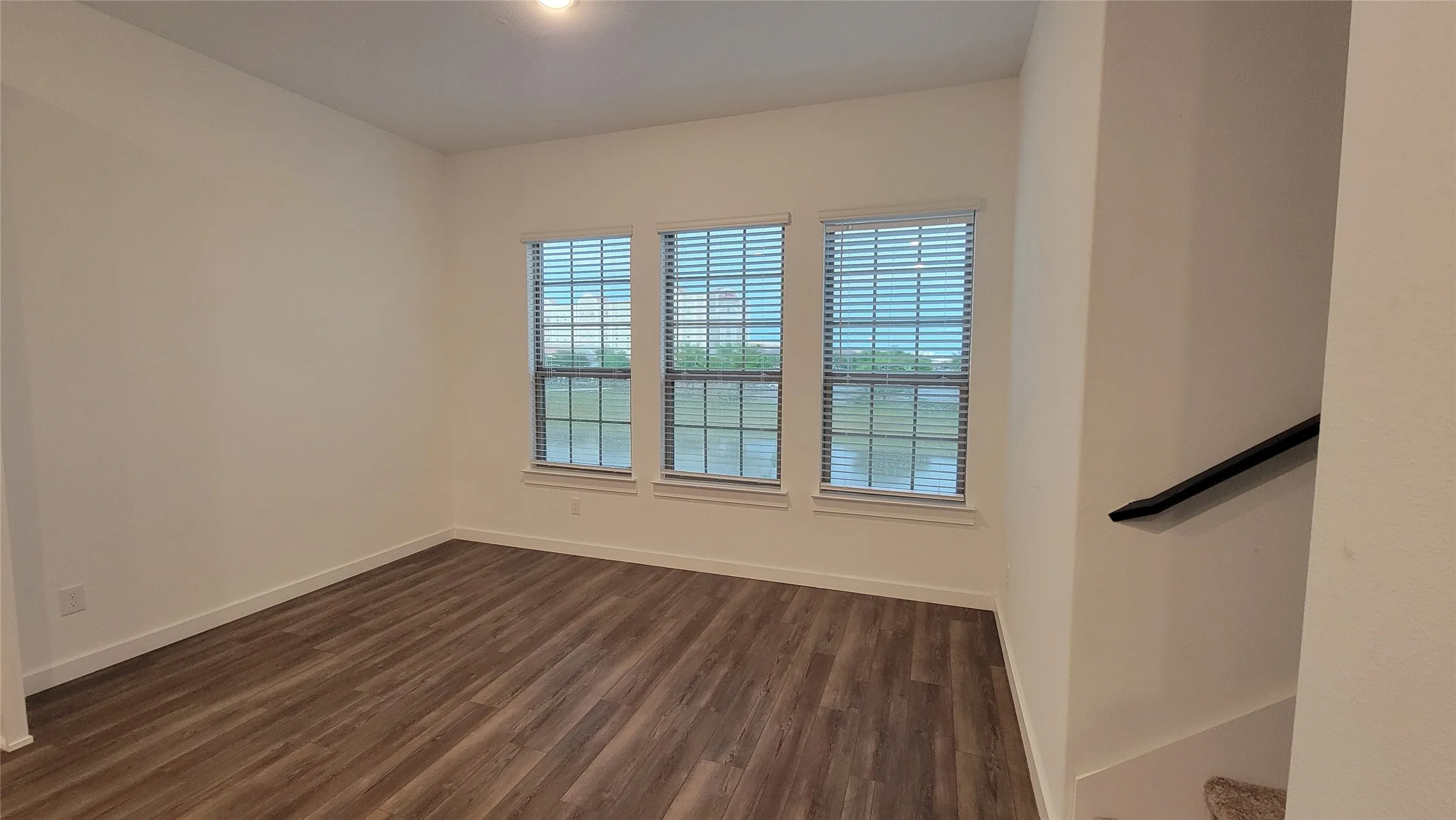 Unfurnished room featuring dark hardwood / wood-style floors