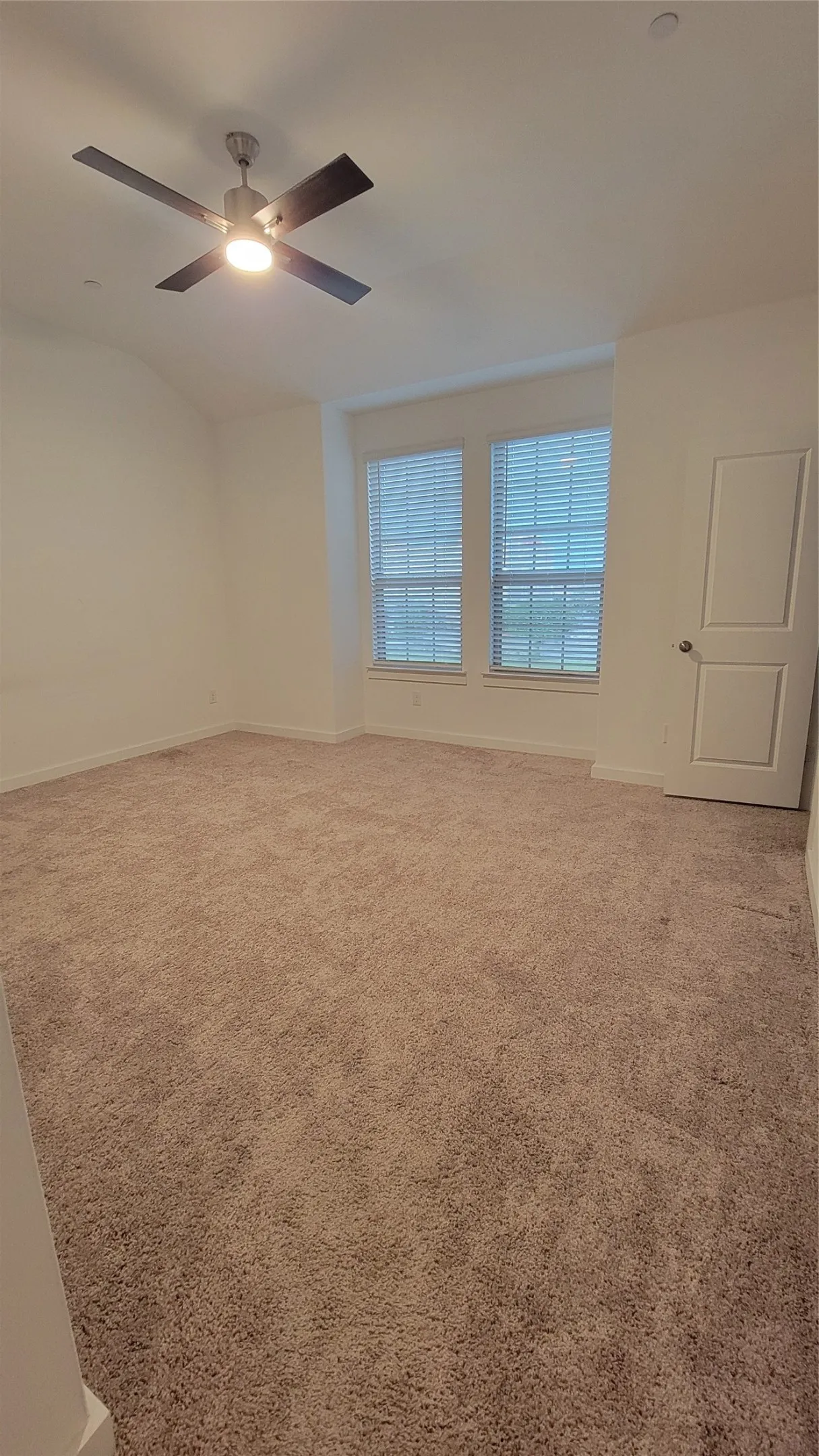 Empty room with carpet and ceiling fan