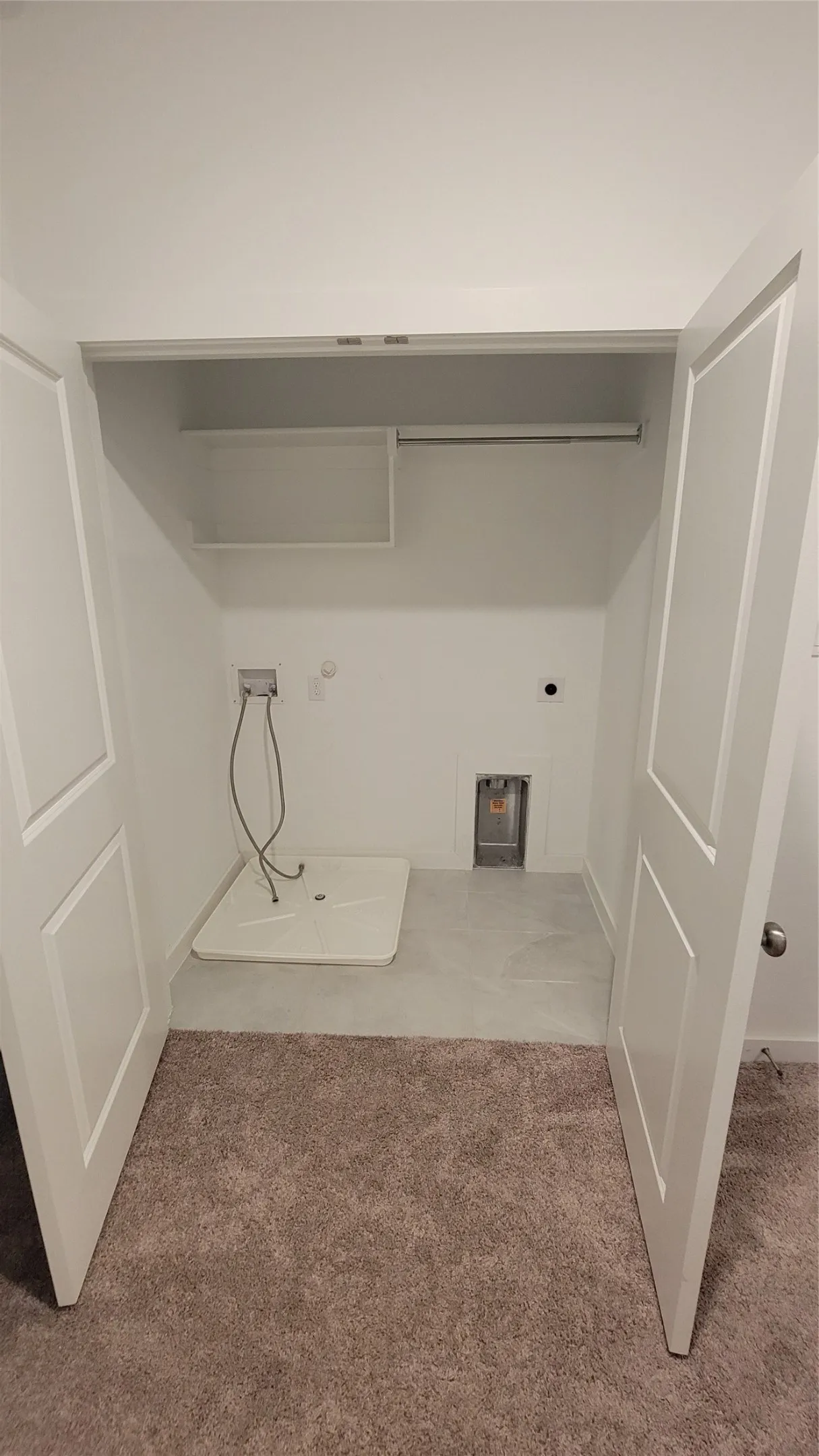 Clothes washing area featuring carpet floors, washer hookup, and electric dryer hookup