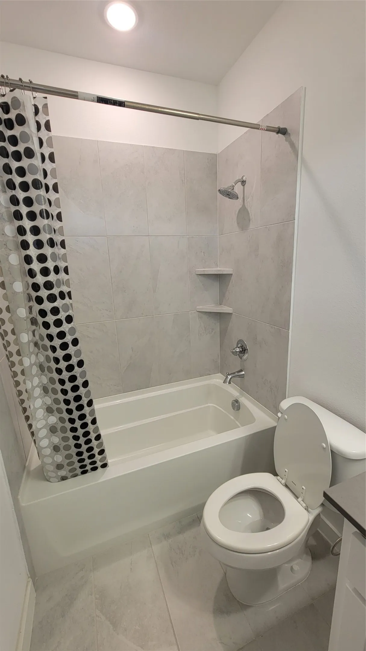 Full bathroom featuring tile floors, shower / bath combo, toilet, and vanity