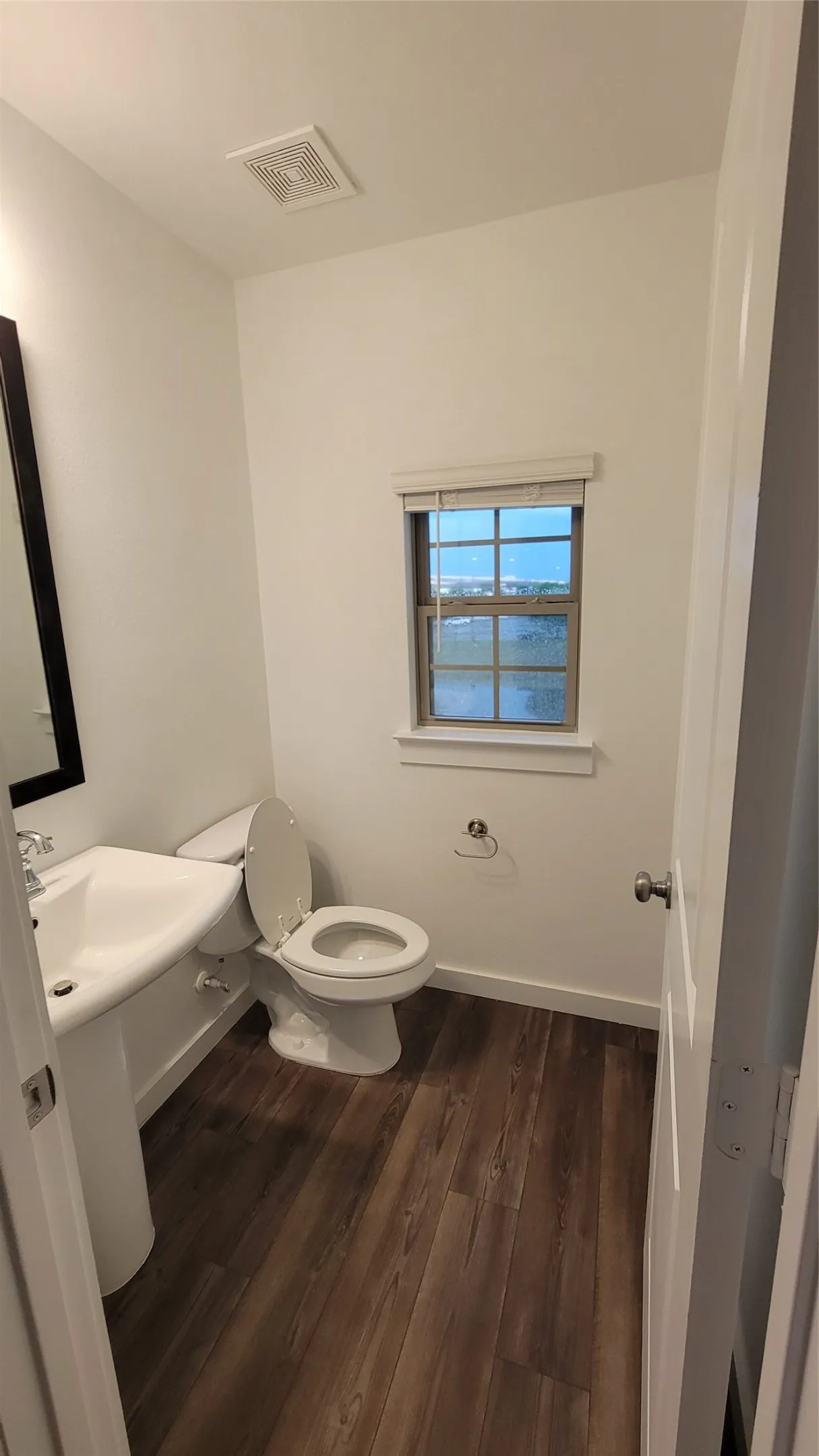Bathroom featuring wood-type flooring and toilet