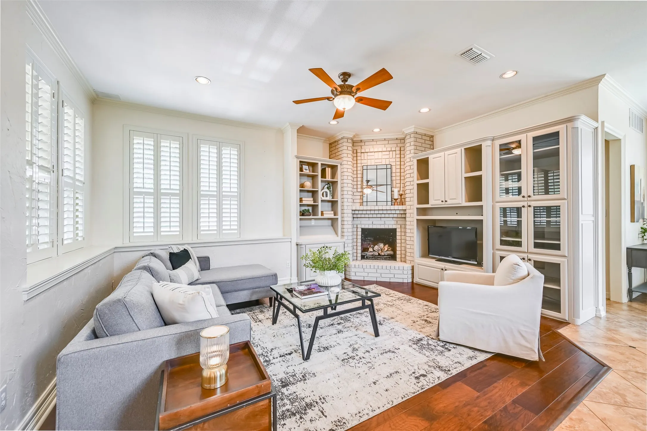 Den area off kitchen has ample built-in cabinets, a cozy fireplace, and is the perfect place to relax.