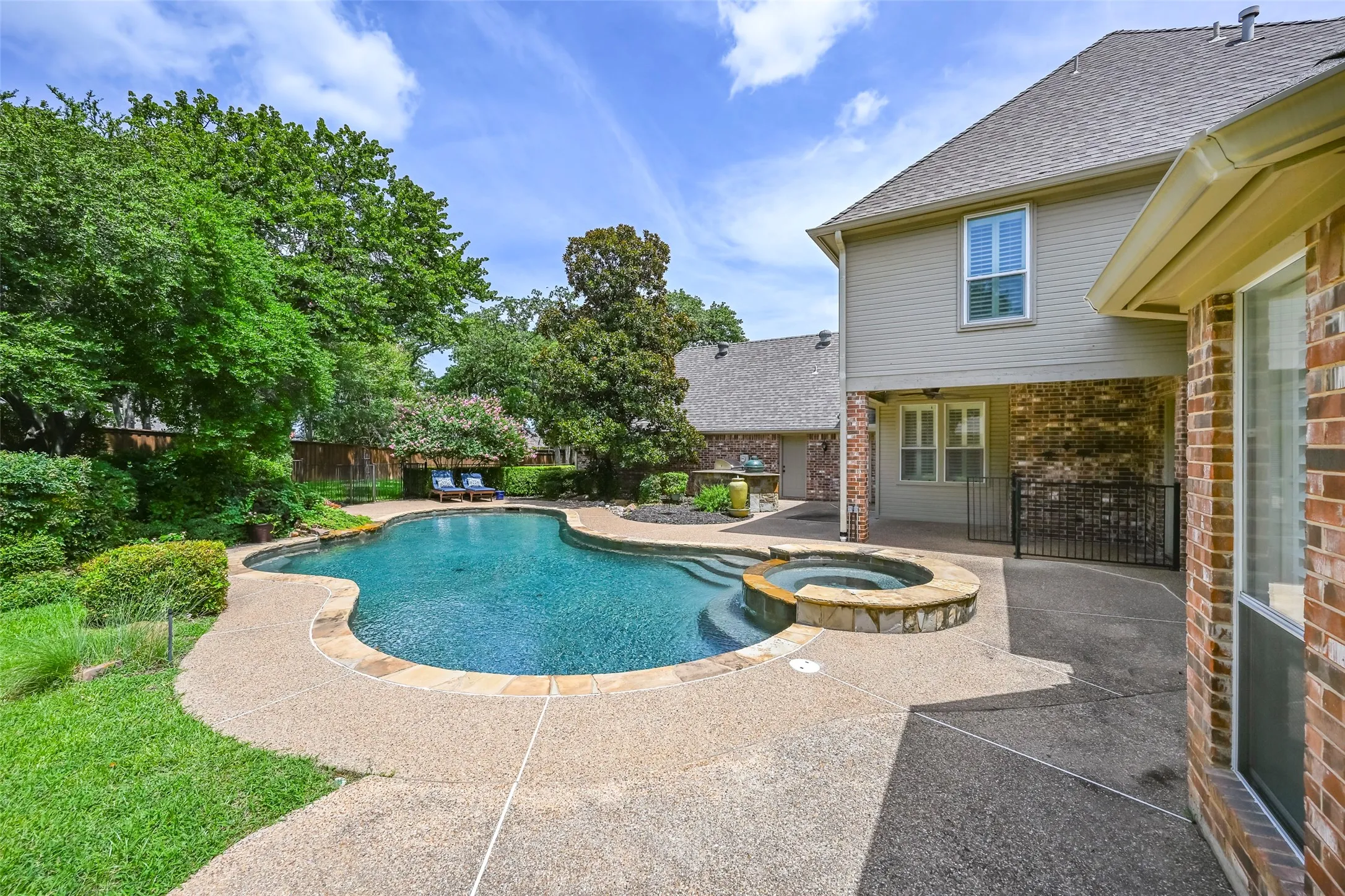 The stunning backyard oasis complete with outdoor grill/green egg.
