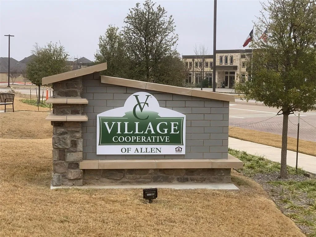 Entryway sign featuring stone and brick construction with a sloped capstone