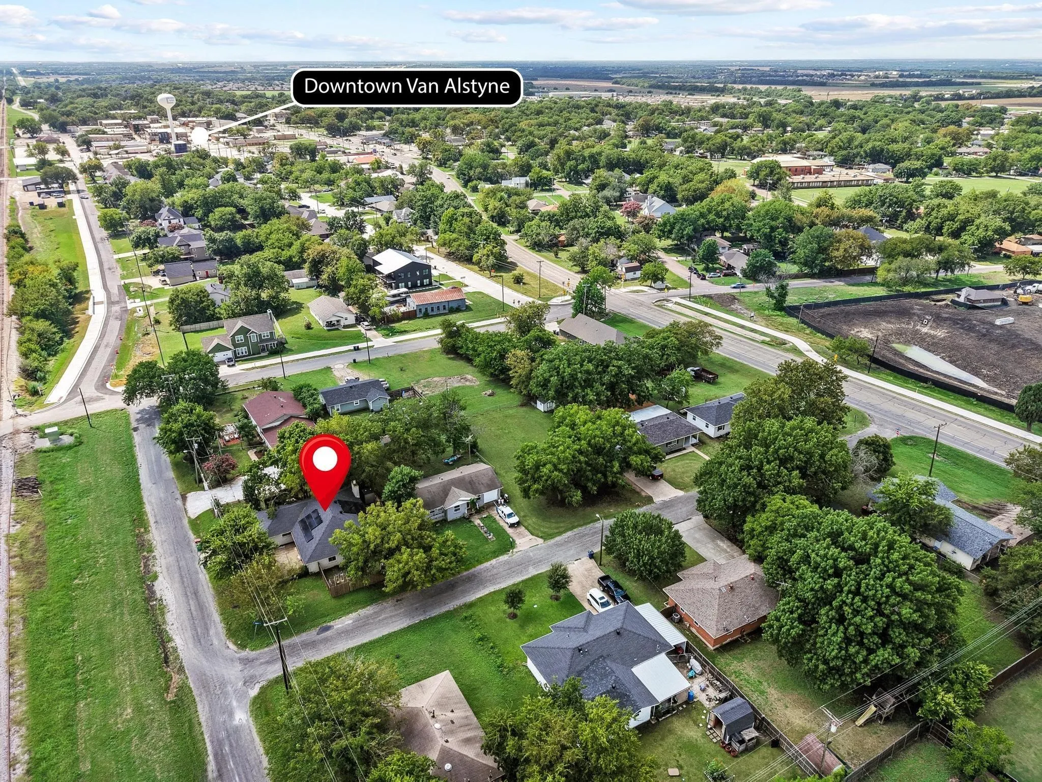Aerial perspective showcasing a residential neighborhood with established trees