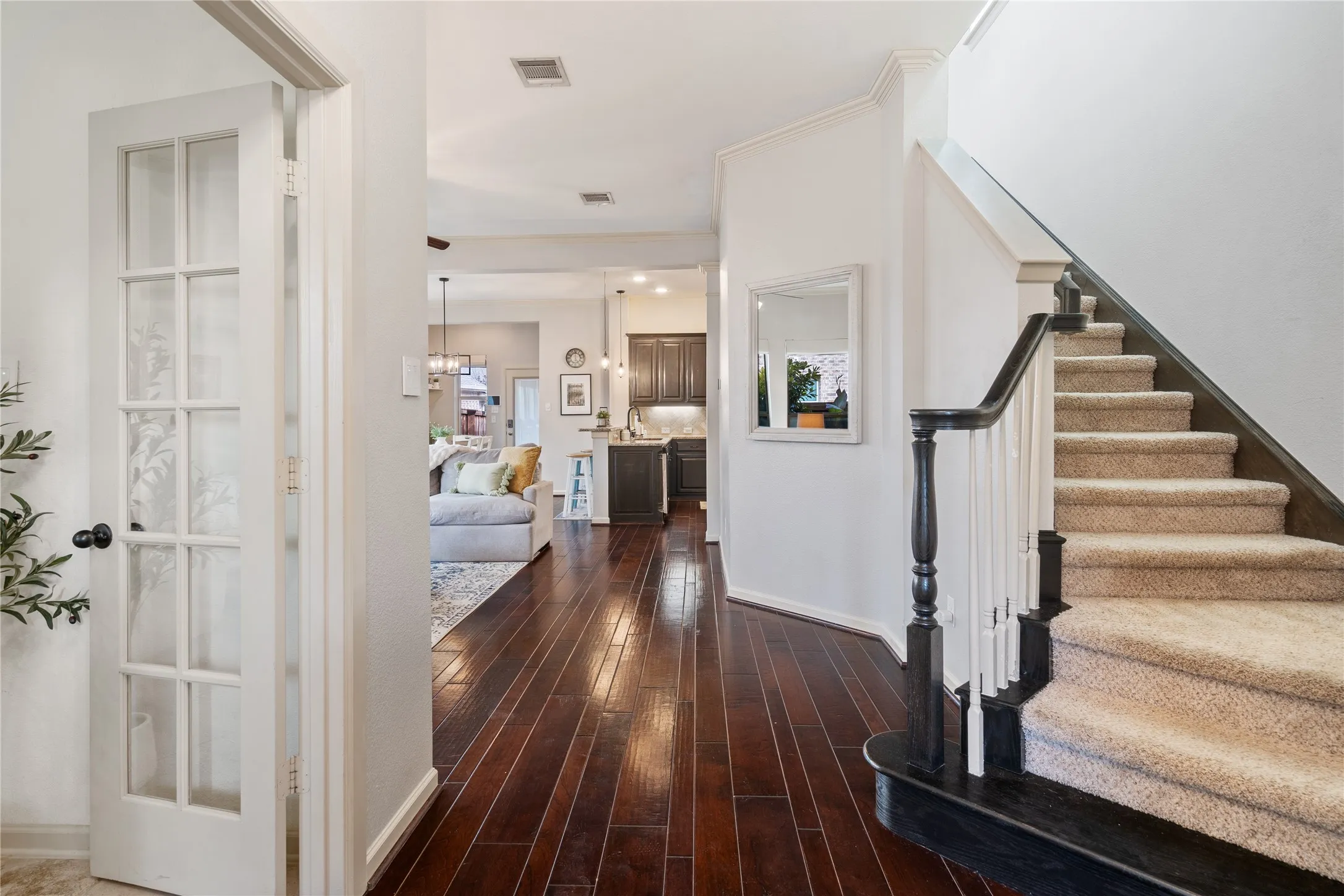 Dark wooden handrails takes you the two secondary bedrooms with the second living area and full bath.
