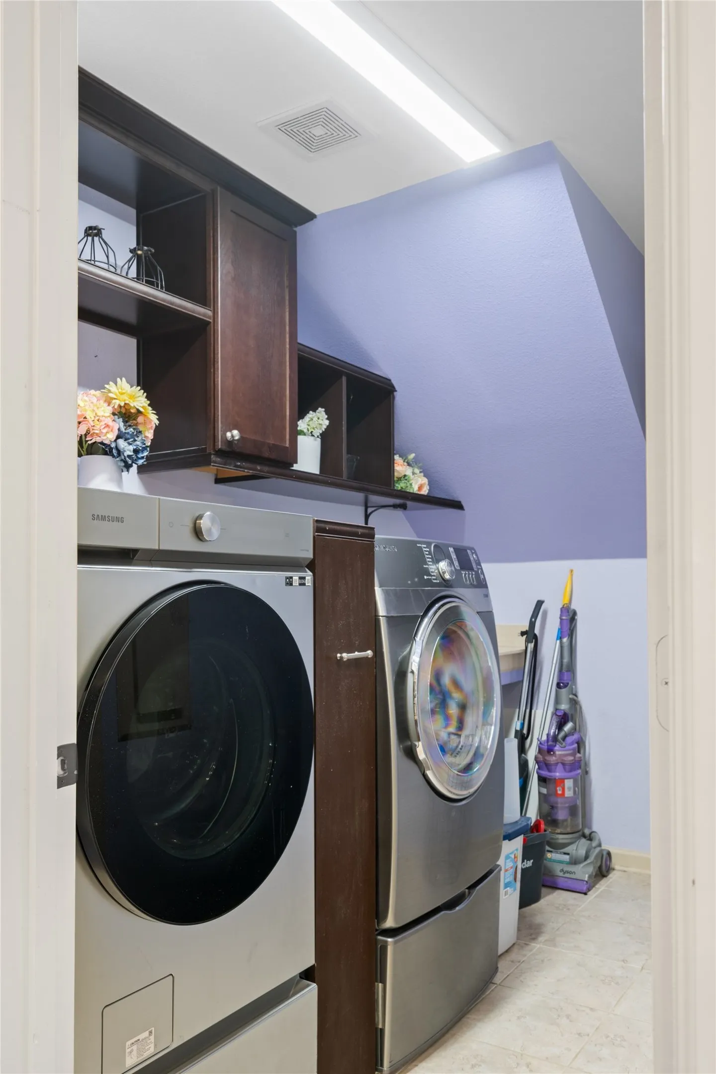 Laundry room with Cabinets by Design