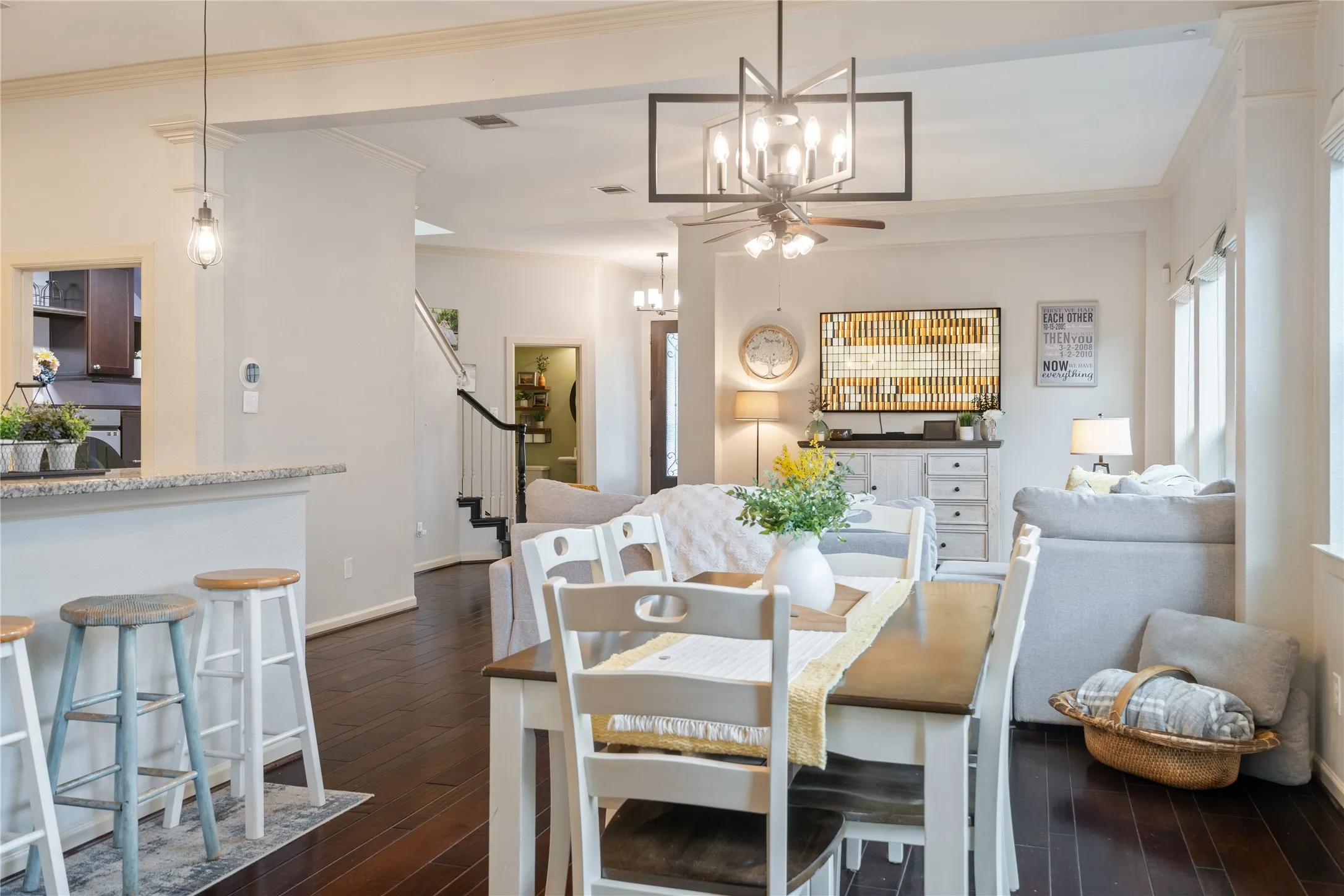 Open-concept living area, kitchen and dining area separated by granite topped bar.