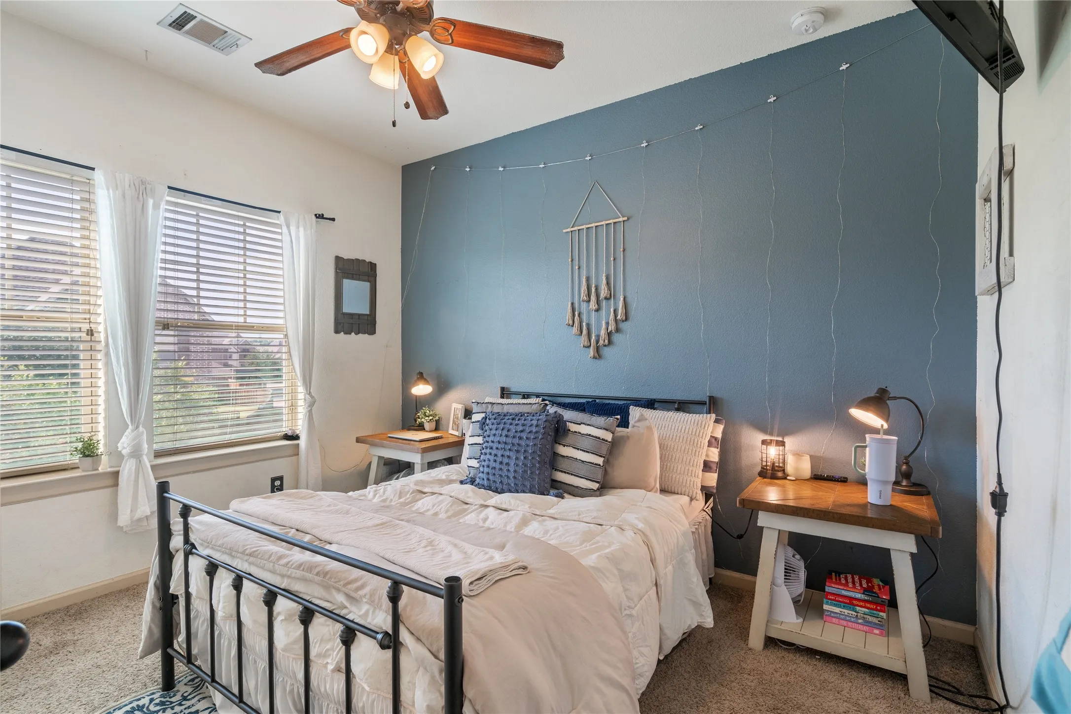 Bedroom 3 with two windows with blinds, and a contrasting accent wall