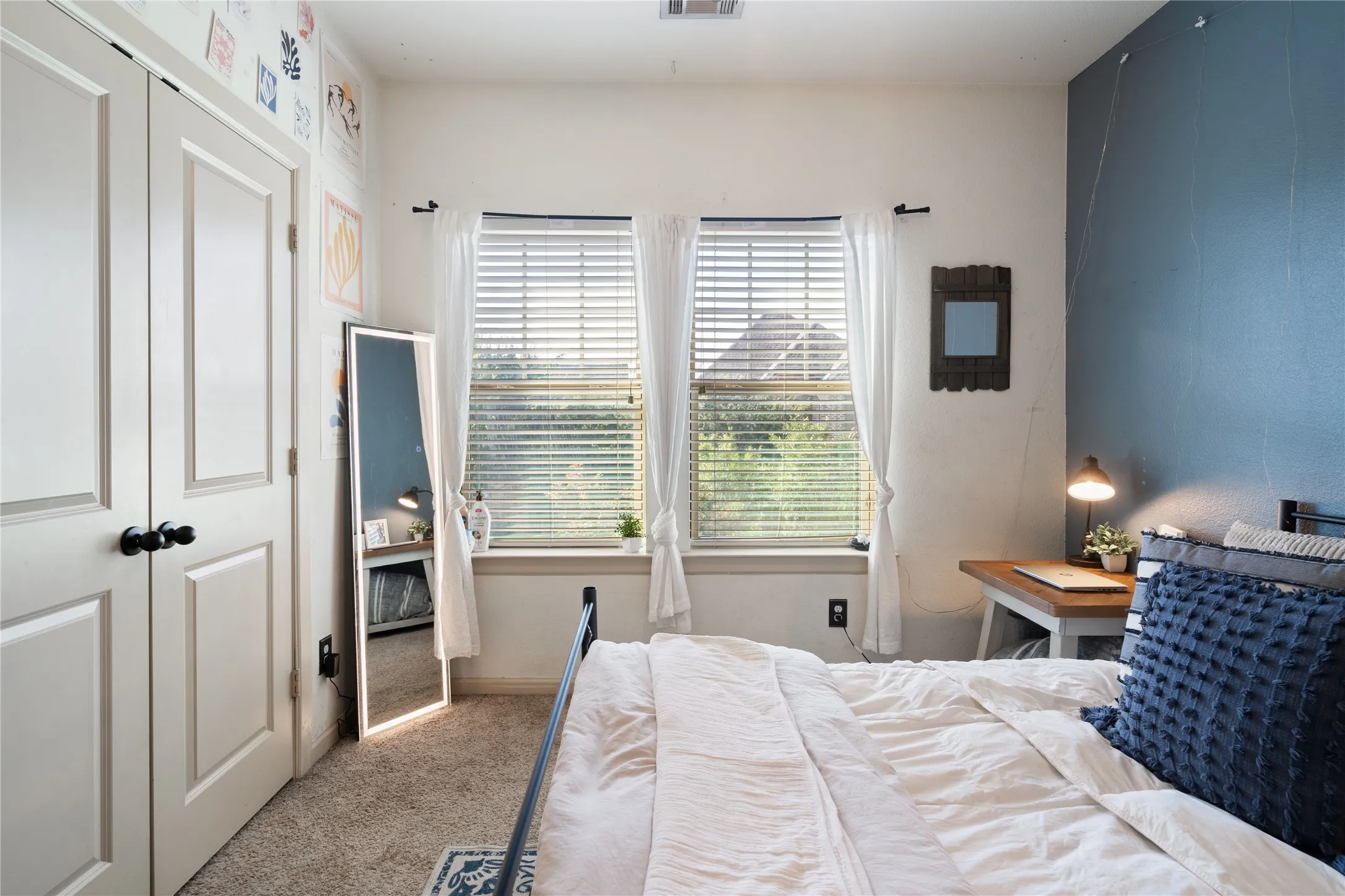 Bedroom number 3 and just behind the two paneled closet doors is the customized closet.