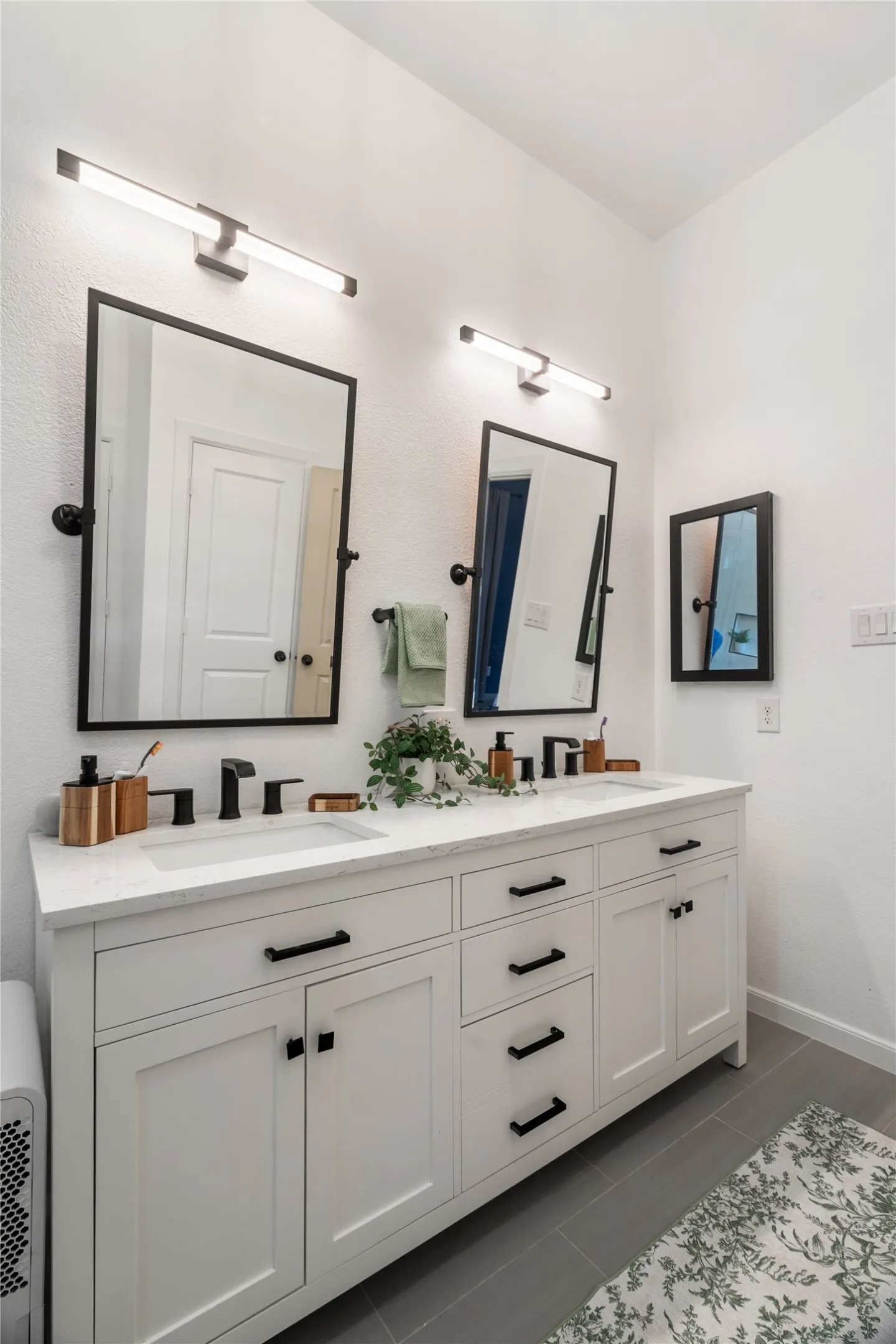 Dual vanity with shaker-style cabinetry, quartz countertop, and rectangular undermount sinks