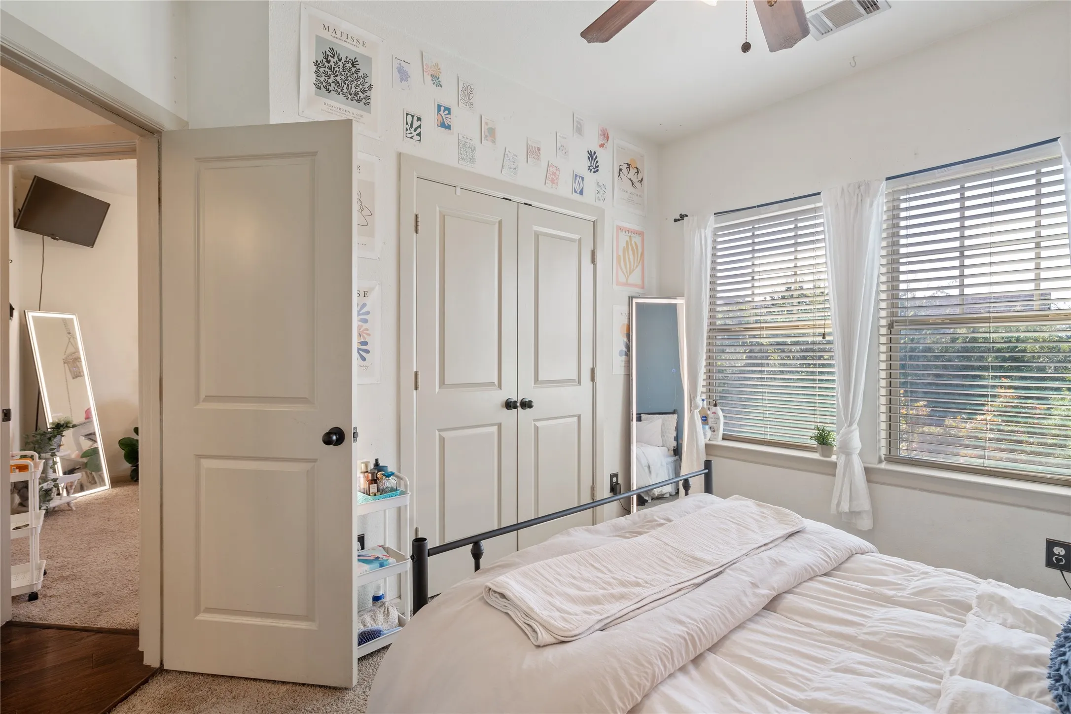 Upstairs bedroom number 3 with natural light and customized closets done by "Closets by Design".