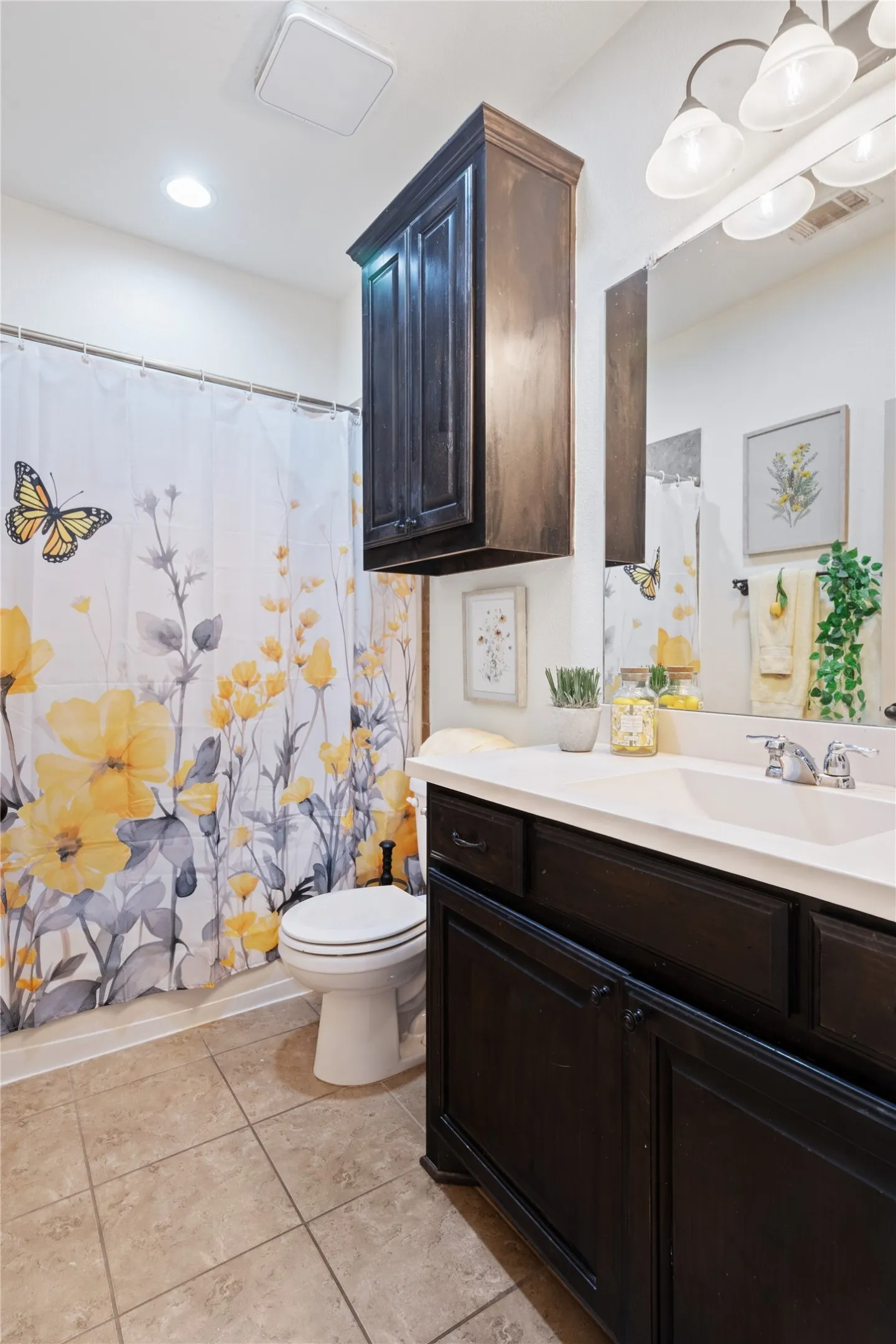 Bathroom featuring a dark wood finish vanity with a white countertop and integrated sink
