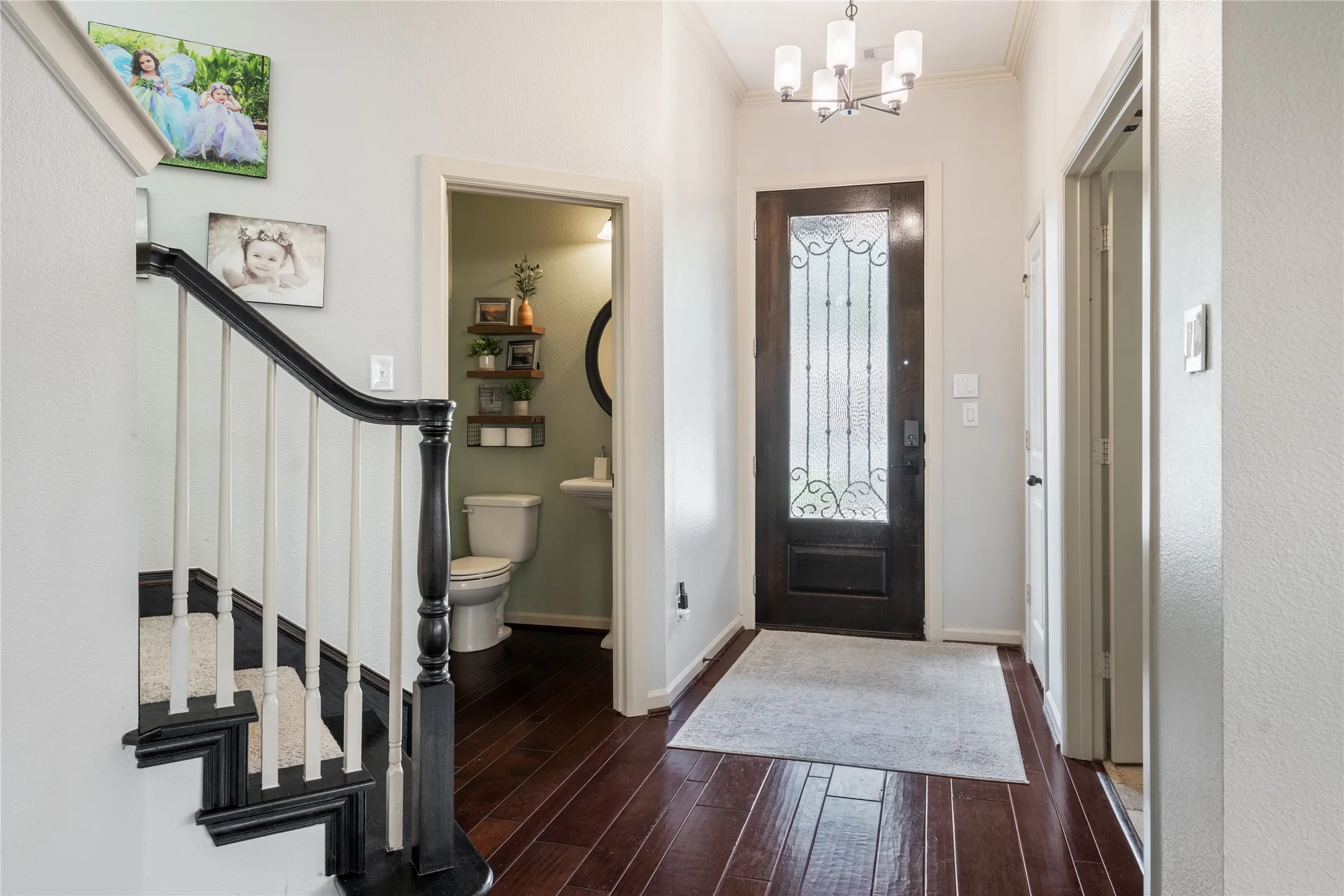8 X 3 foot Dark wood and wrought iron entrance door with removable glass panel opens into the front foyer.