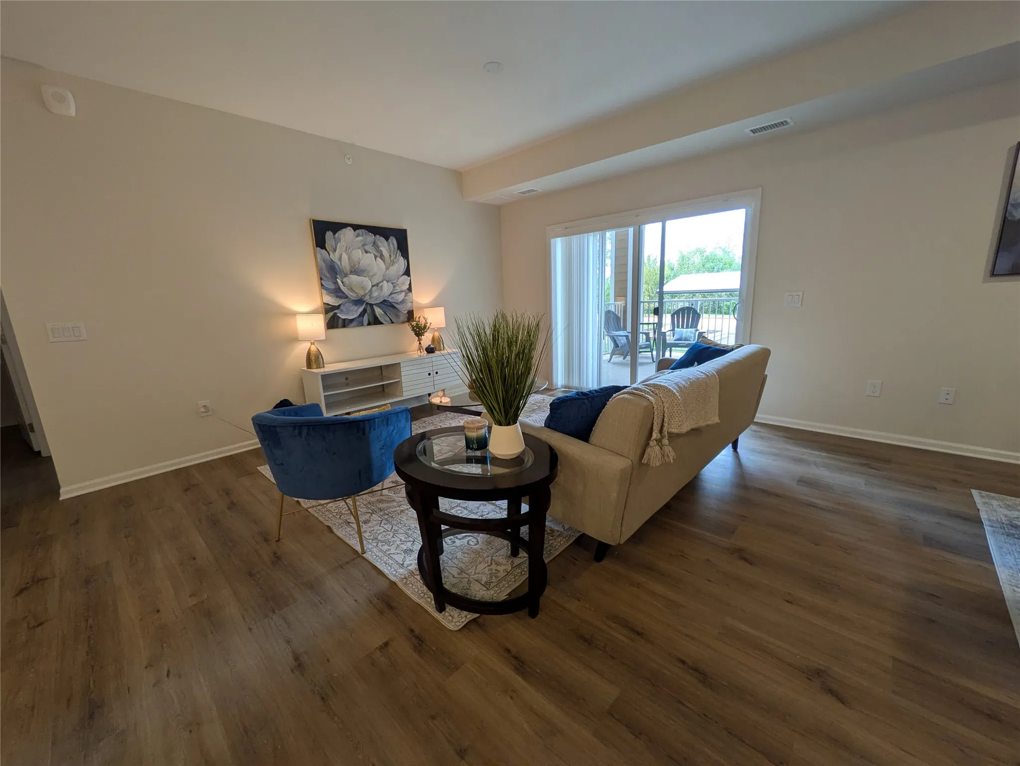 Living area featuring wood-finish flooring, light-toned walls, and recessed lighting