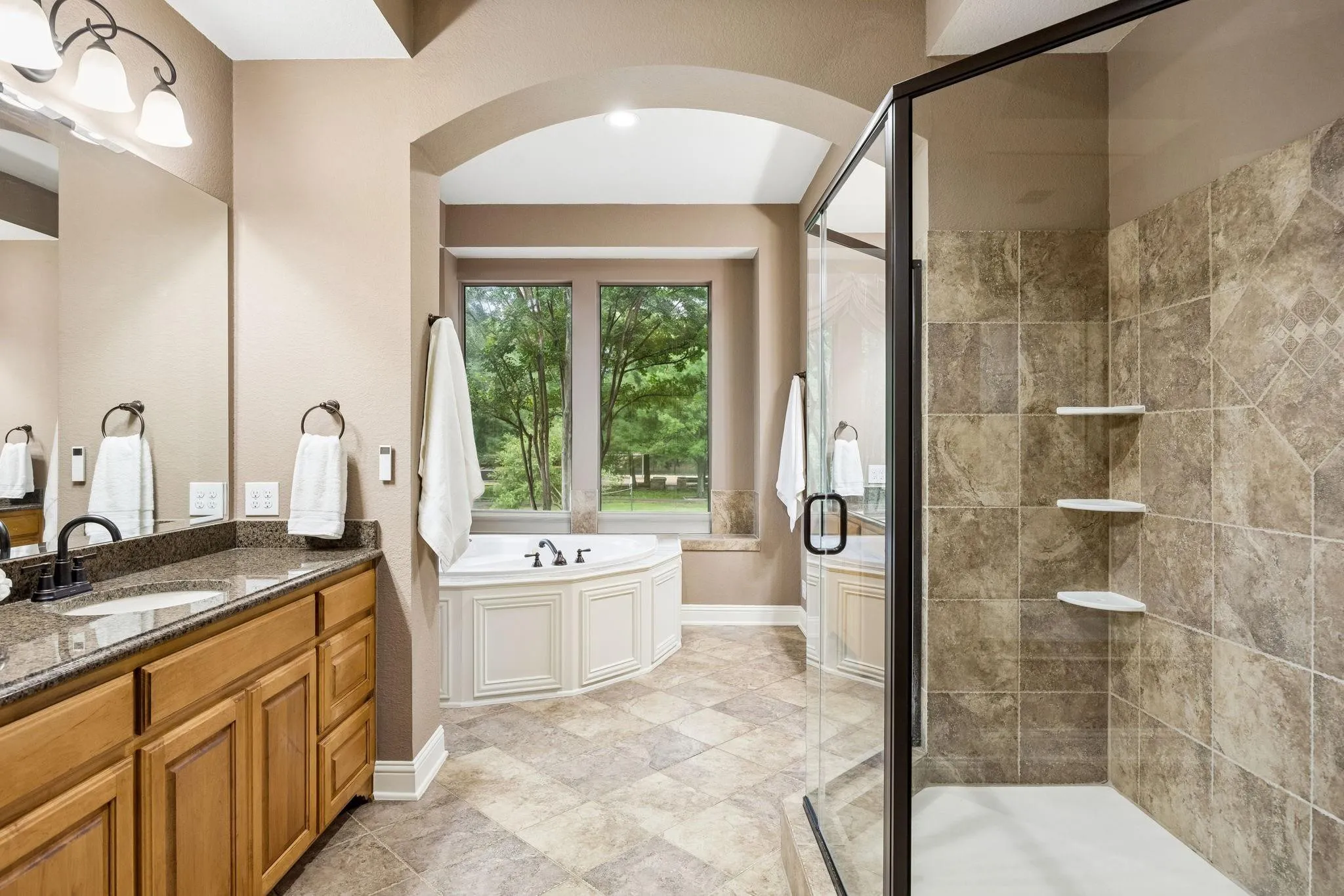 The primary suite has an expanded walk-in closet,
en suite bathroom, carpet, crown moulding and ceiling fan. (Window coverings are present but not shown in photo)