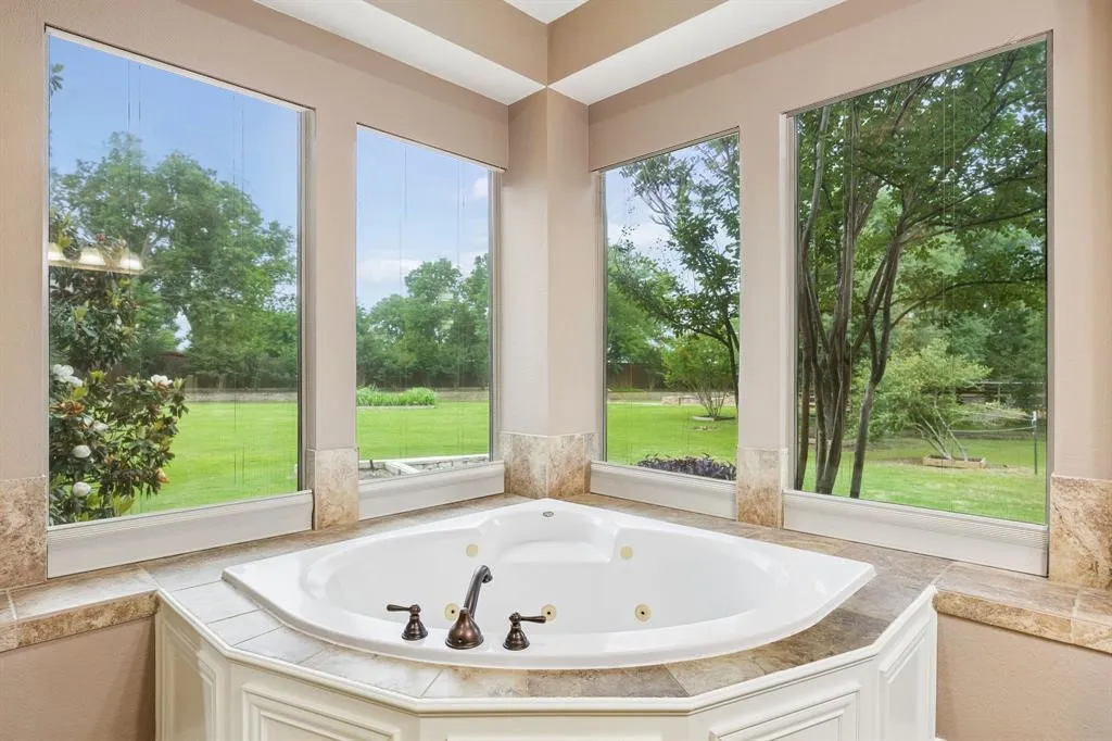 The primary bathroom offers dual vanities with
granite countertops, great storage and tons of natural light (Window coverings are present, not shown in picture)
