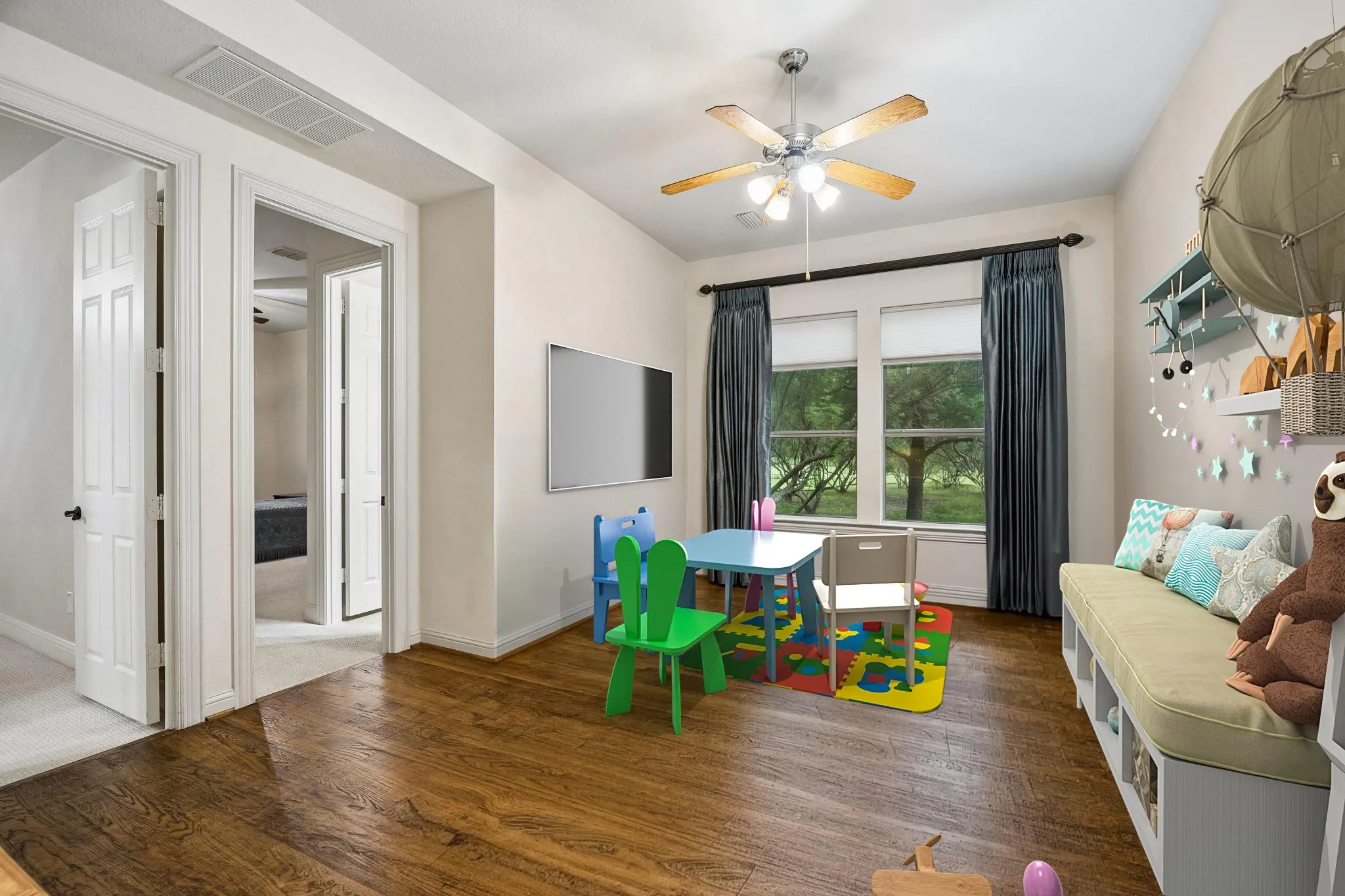 The children's retreat offers a space for a separate
sitting area whether for kids and homework or
multigeneral living quarters. The room has a built
in desk, ceiling fan and hand scraped hardwood
flooring. Two bedrooms are directly off this area.