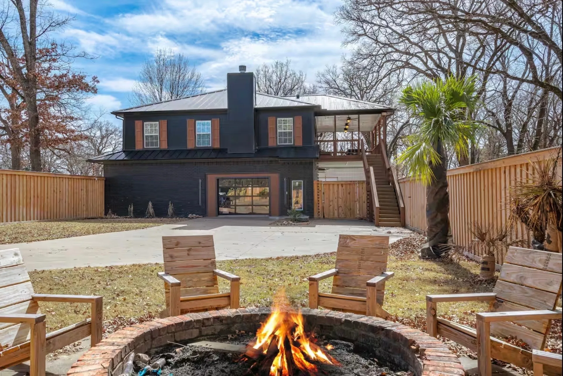 Black exterior with a metal roof and wood shutters