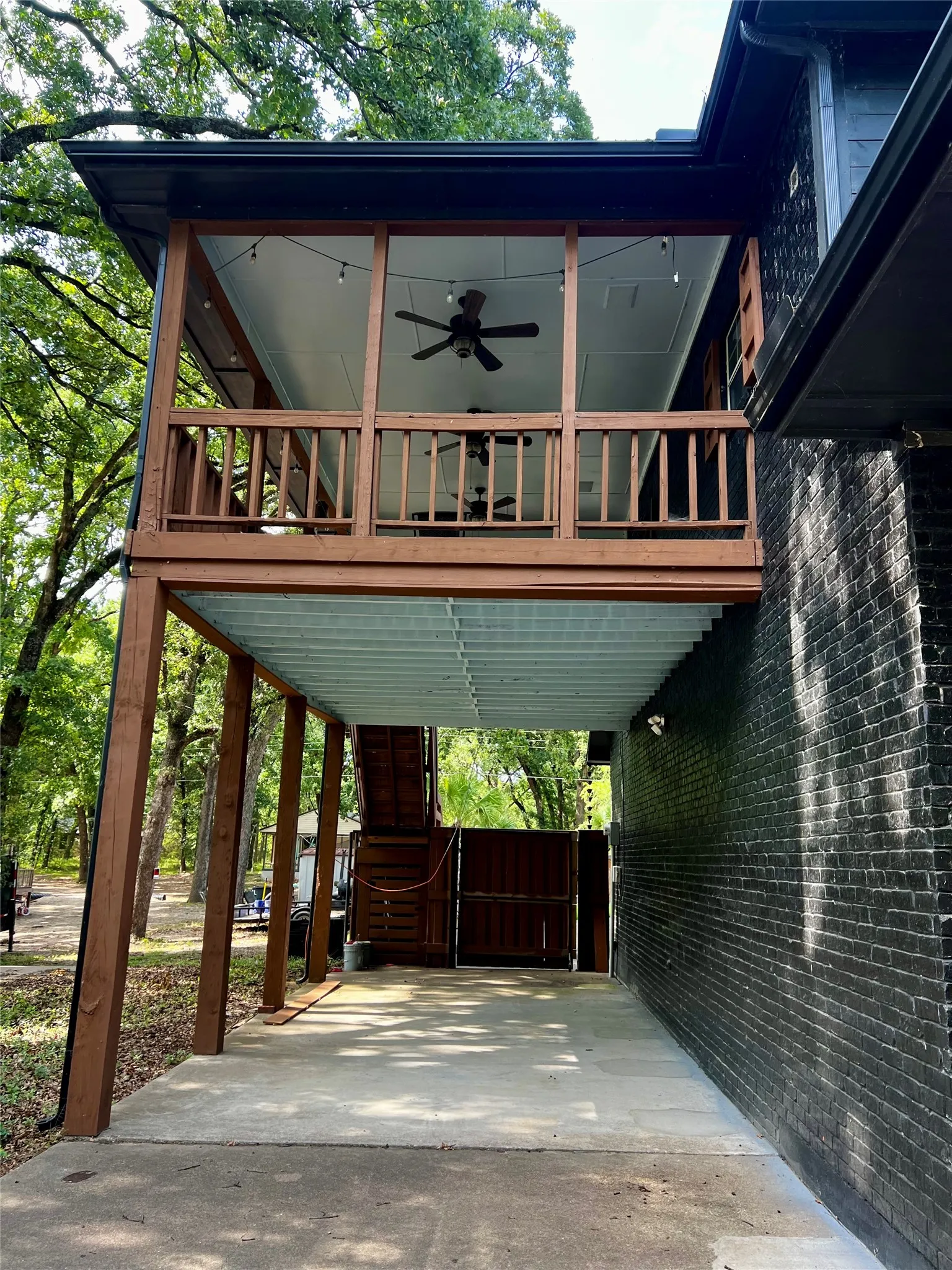 Covered patio or carport and upper entry deck with lake vie