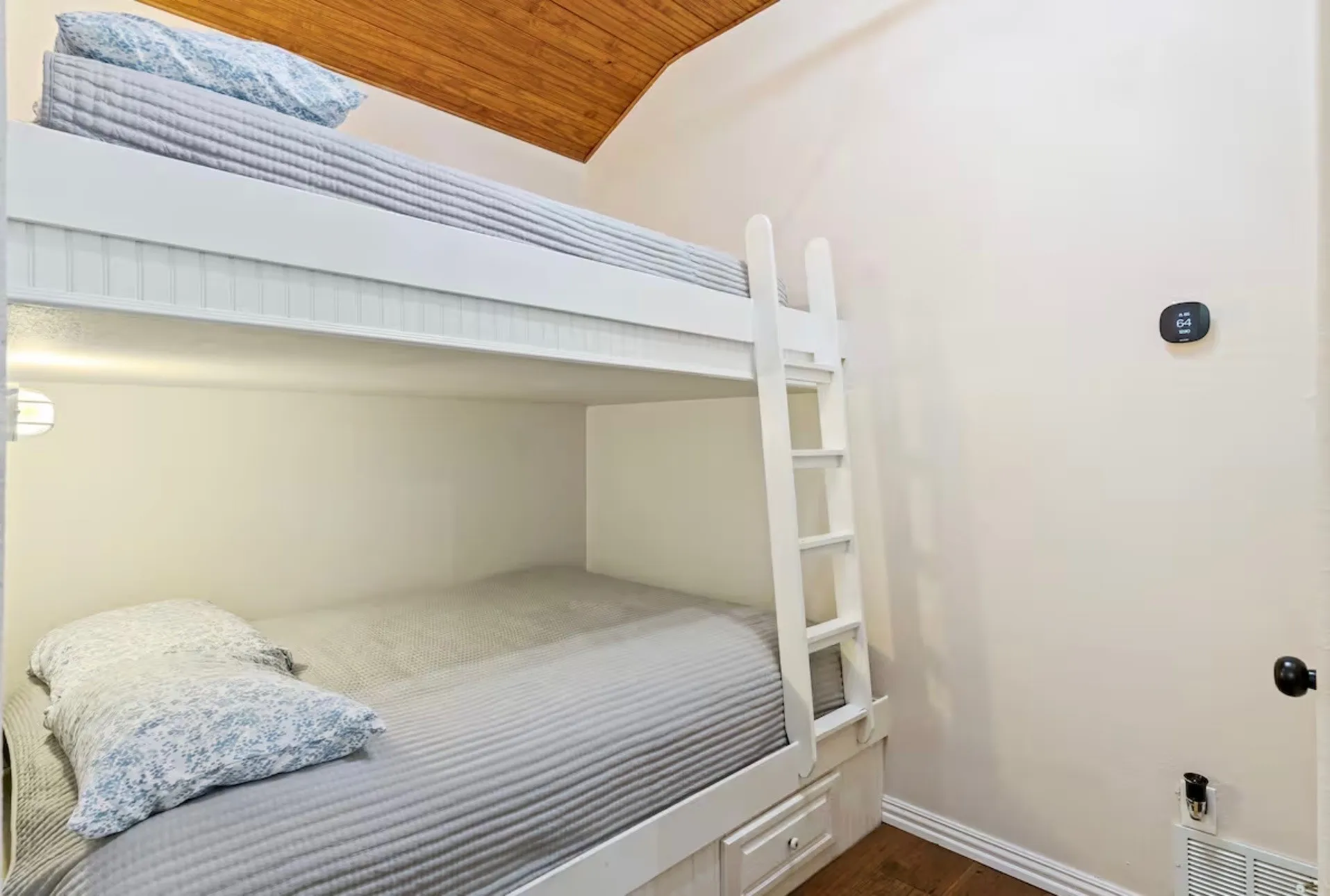 Bedroom 2 - Built-in white bunk beds featuring a ladder and under-bed storage drawers