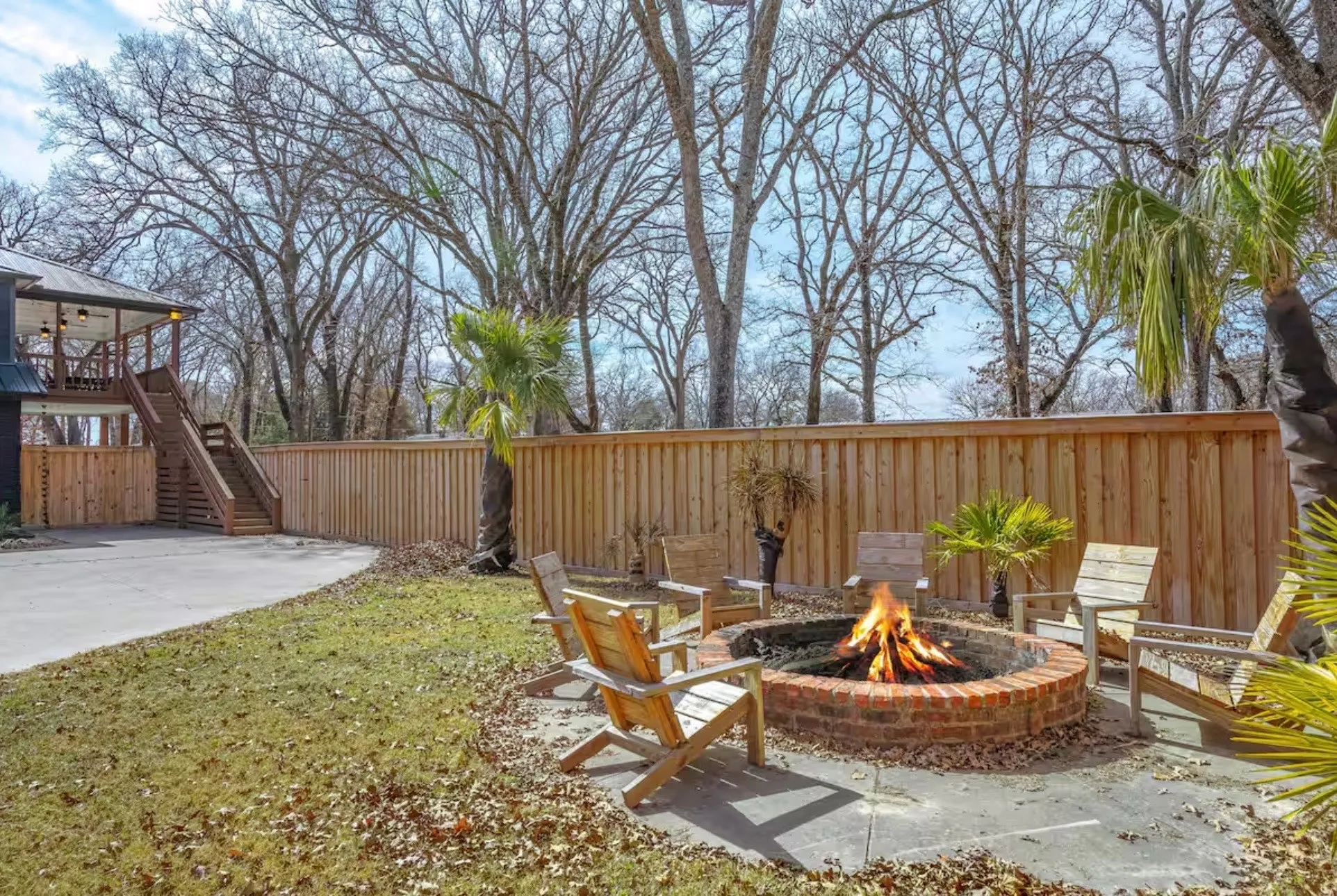 Outdoor fire pit featuring a brick surround and concrete patio