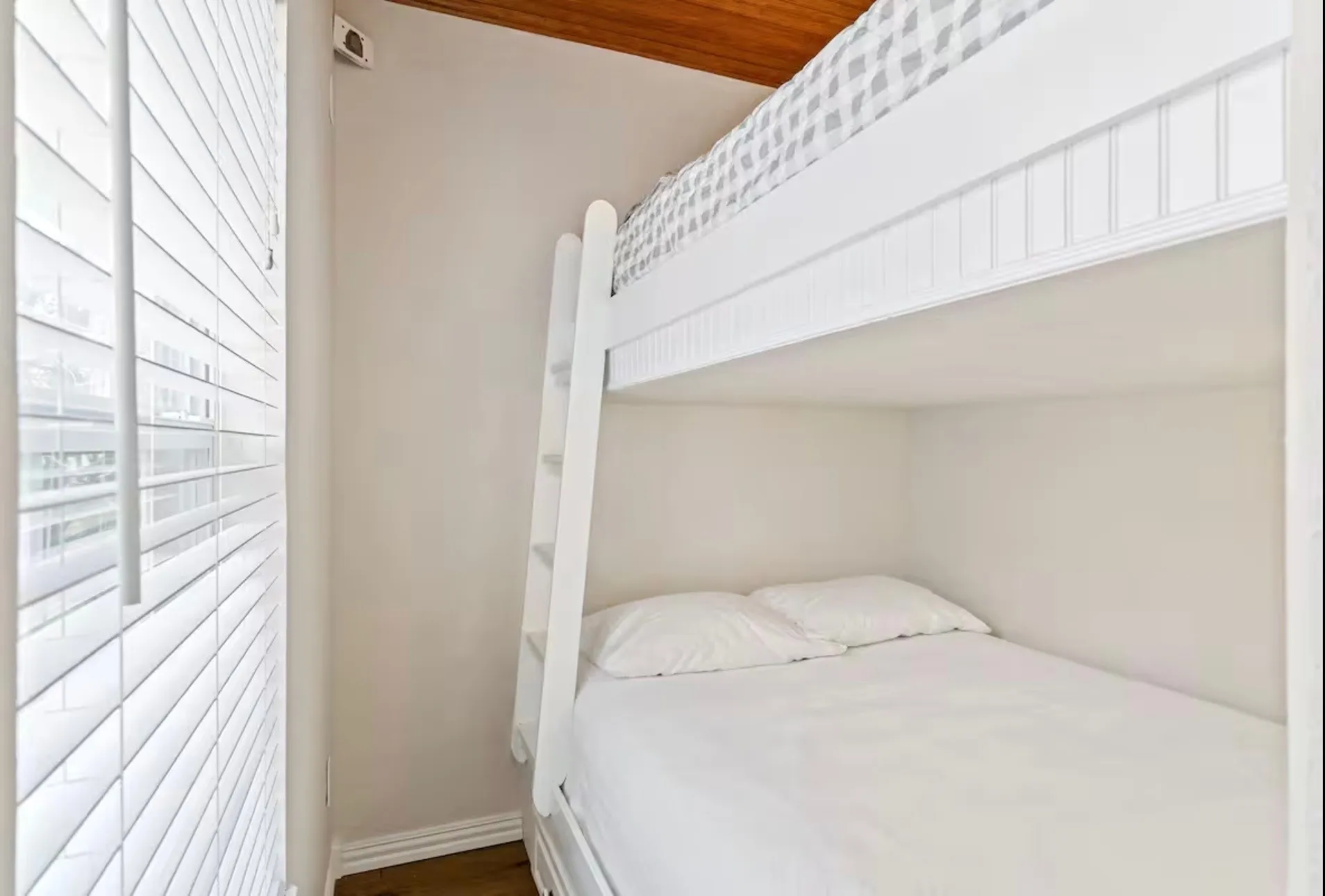 Bedroom 1 - Built-in bunk beds with a white finish, featuring a ladder and bead board detailing
