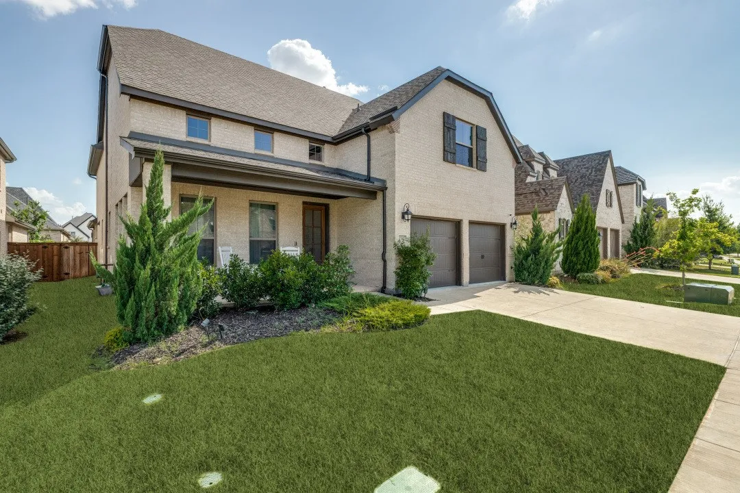 Cream brick exterior with dark trim and a gabled roofline