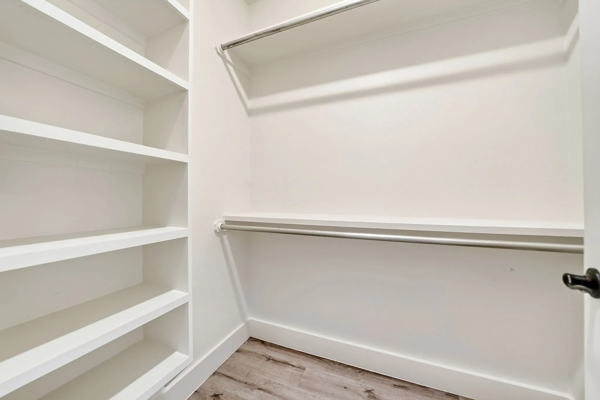 Built-in shelving and dual hanging rods provide extensive storage