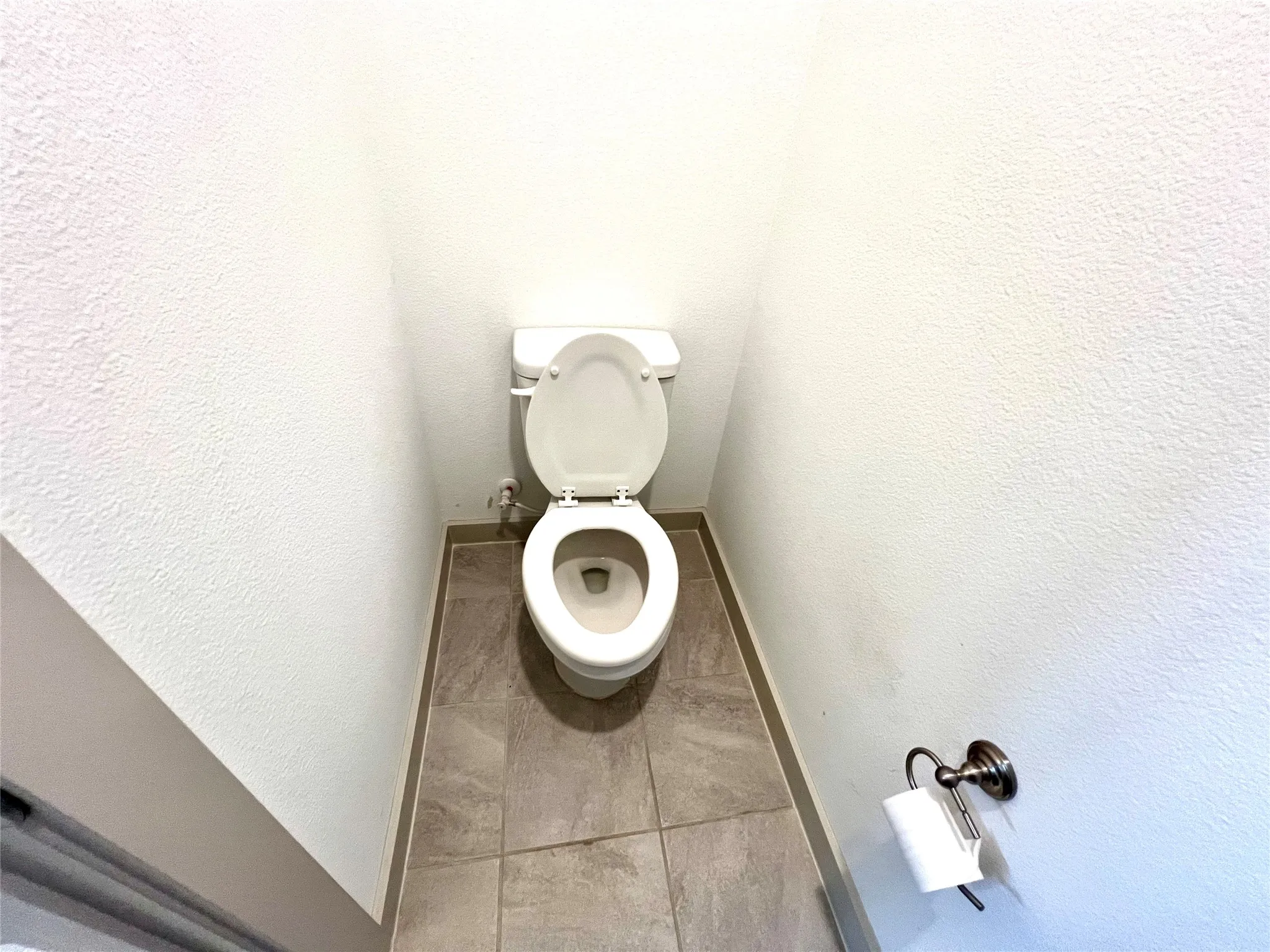 Bathroom featuring tile patterned flooring and toilet