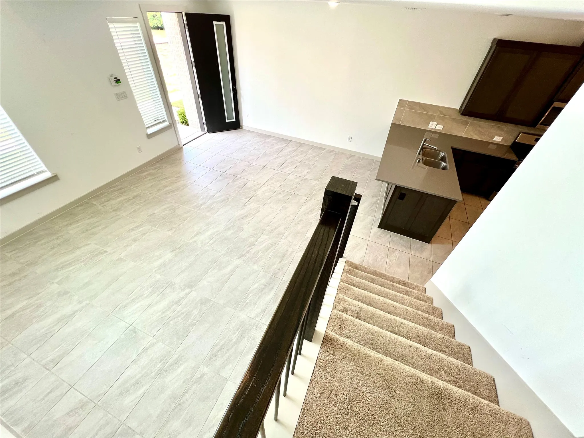 Living room featuring sink and light tile patterned flooring